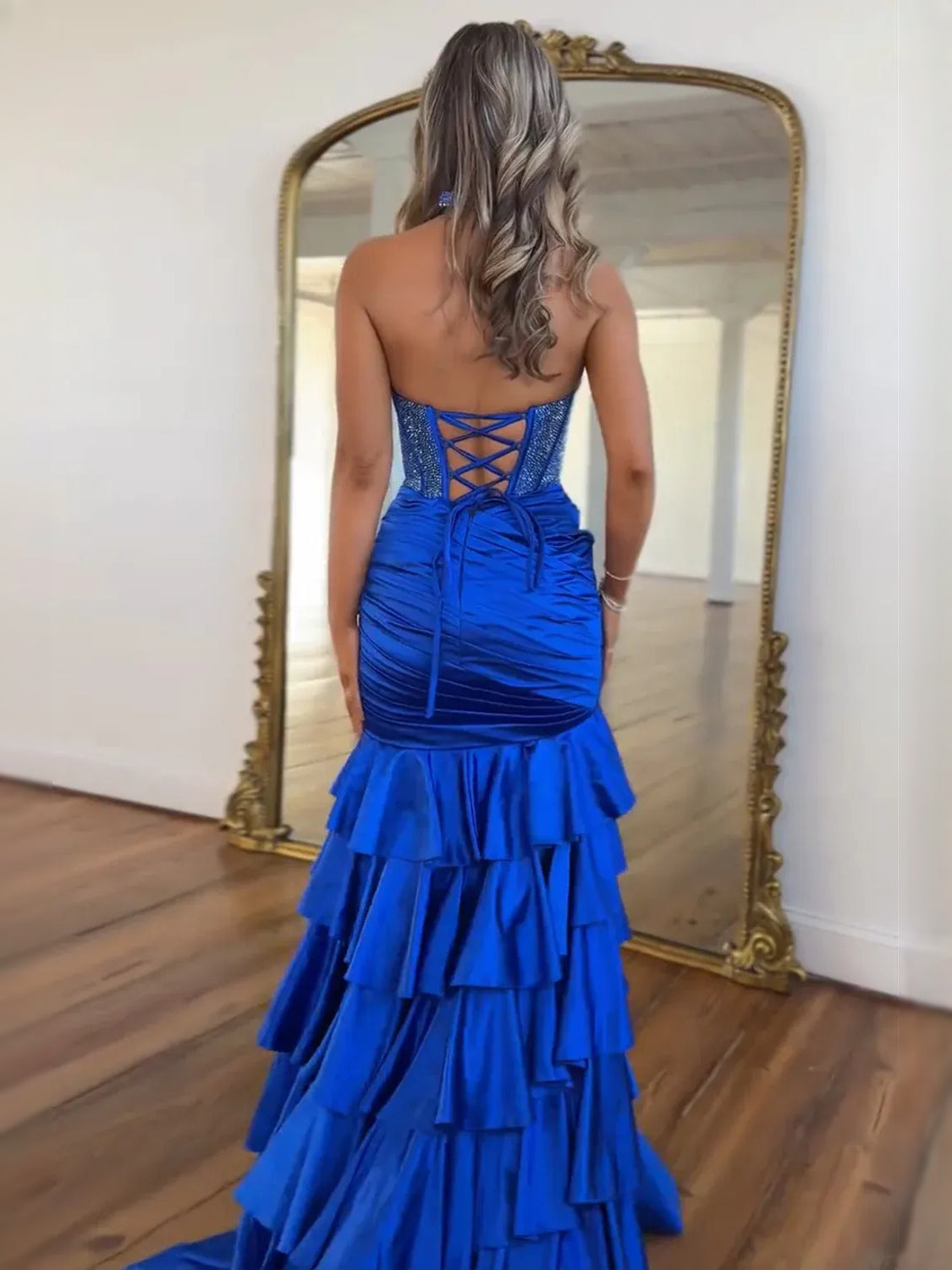Cobalt blue halter prom dress with corset back crisscross lacing and ruffle tiers