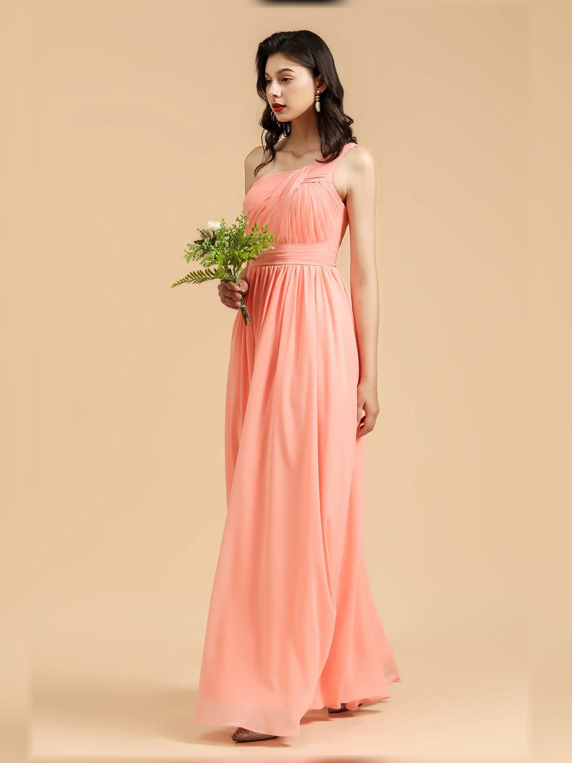 Coral one-shoulder pleated chiffon maxi dress, full length side view.