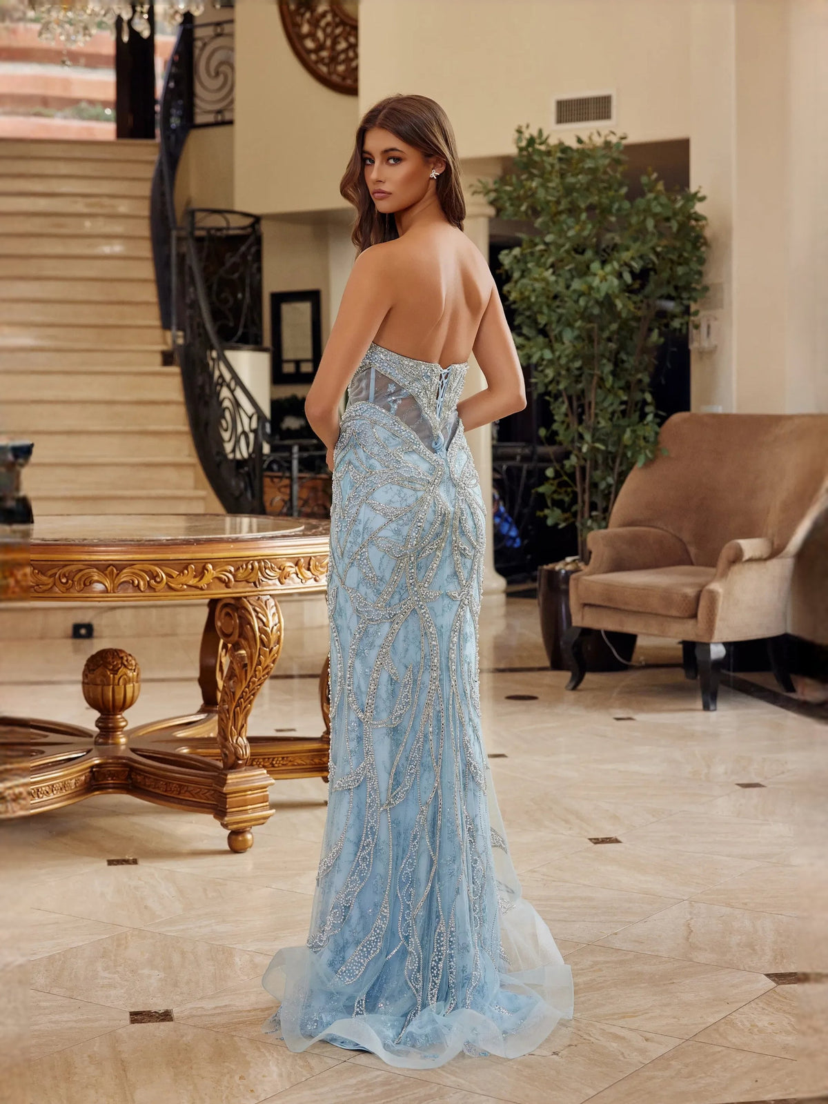 Light blue beaded mermaid prom dress, V-neck corset back view with tulle train