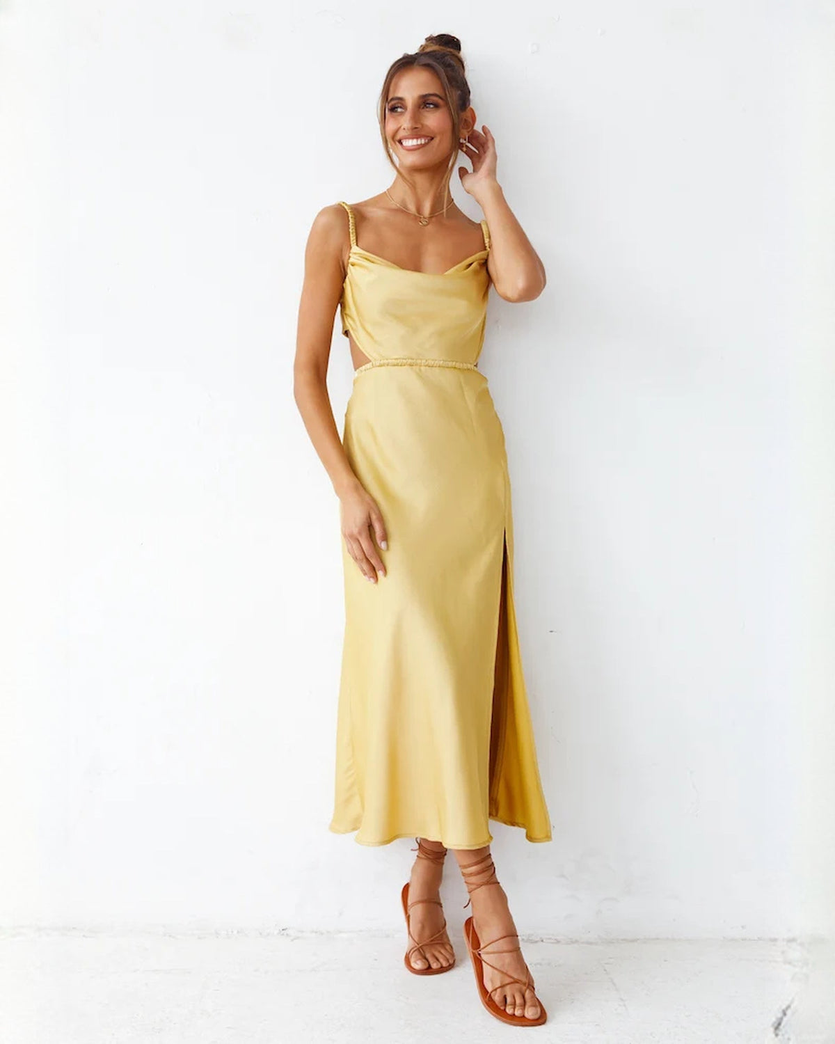 Yellow satin A-line maxi dress with spaghetti straps, fitted waist, and front slit