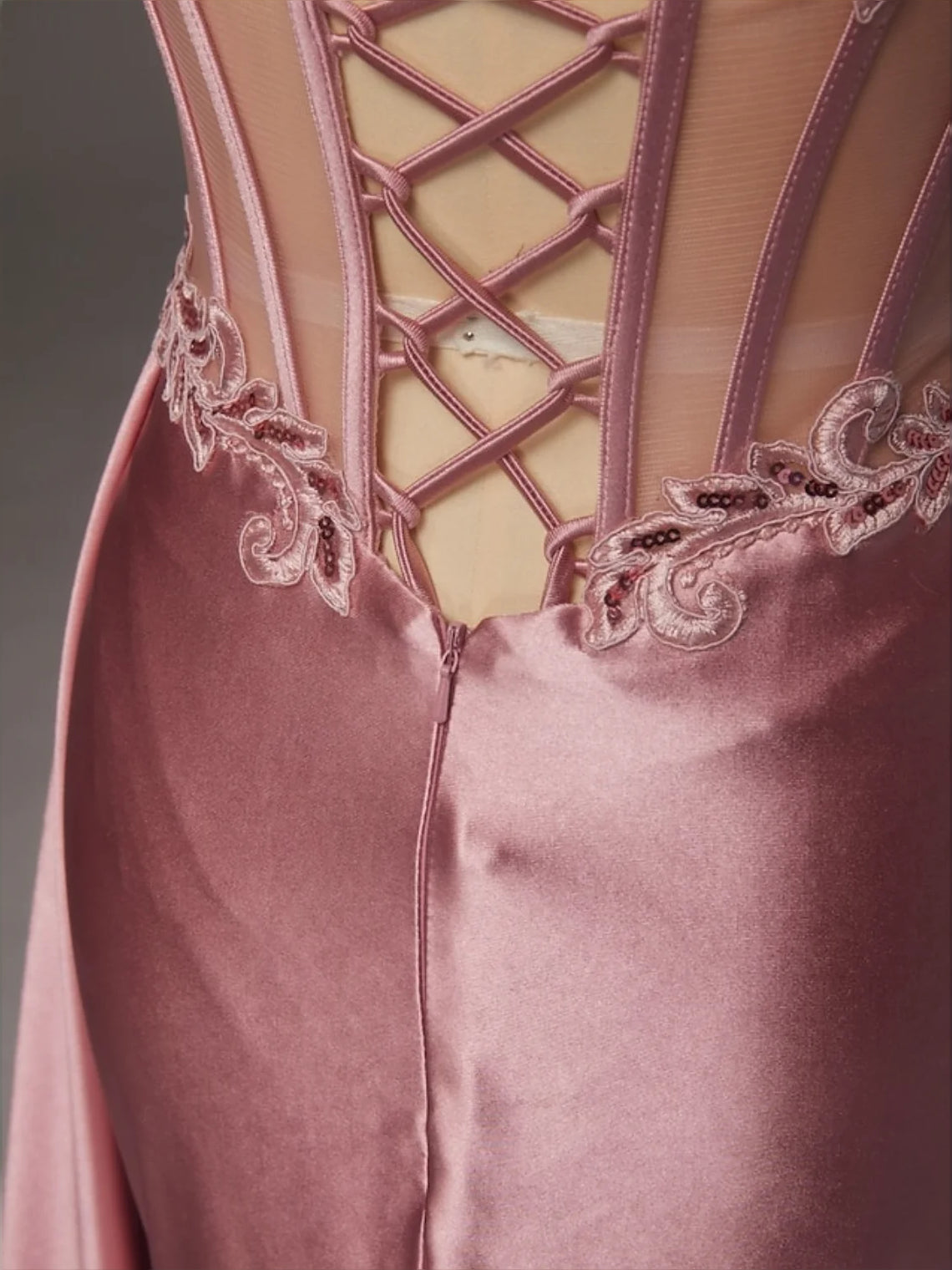 Rose gold satin corset dress with lace-up back detail and embroidered lace trim