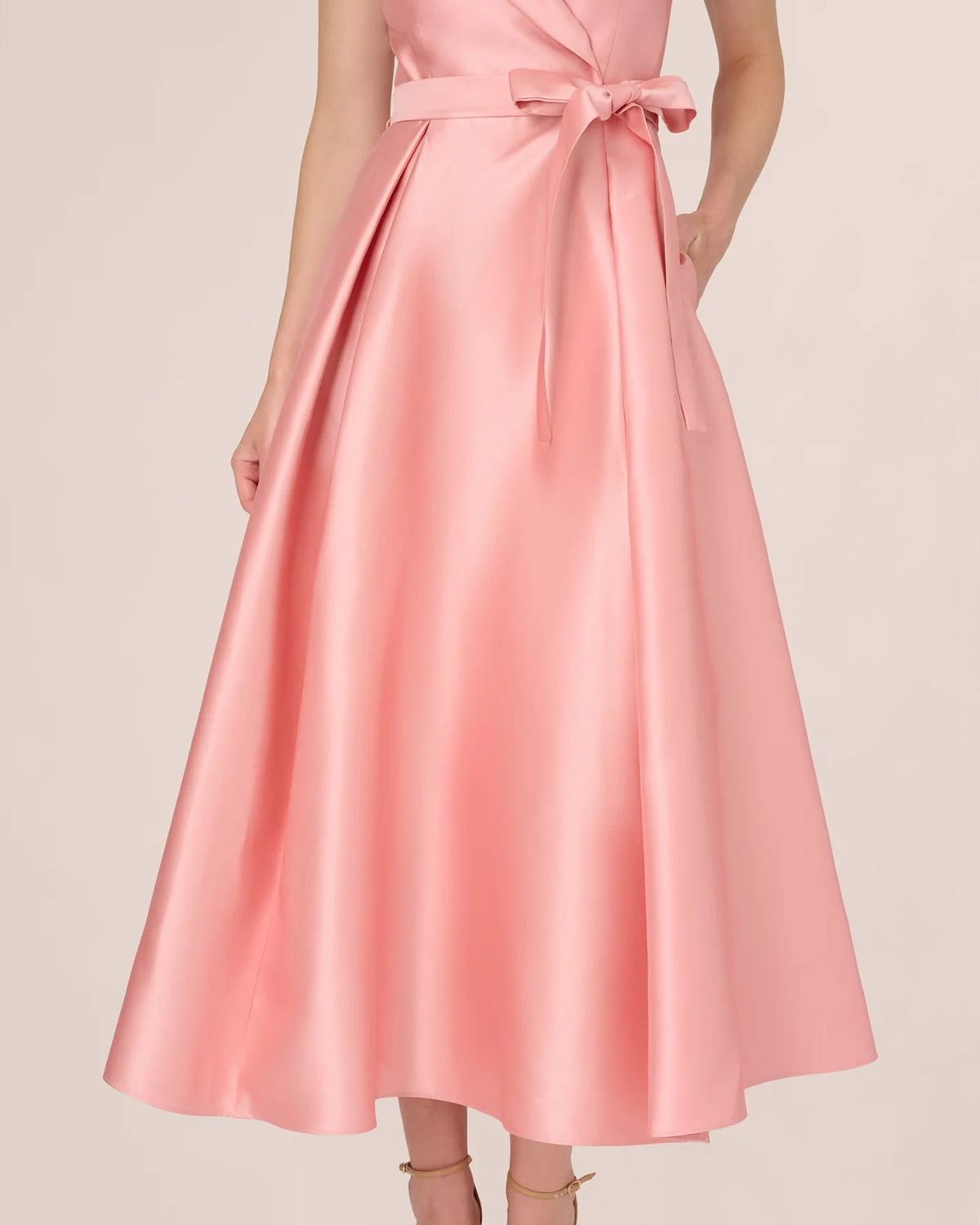 Apricot pink A-line maxi skirt with flared pleats and satin sash waist bow