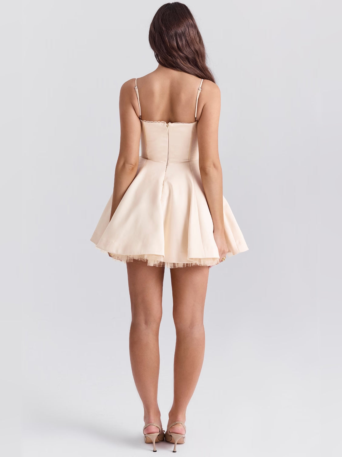 Cream mini dress from back view with open back, thin straps, and tulle-trim hem