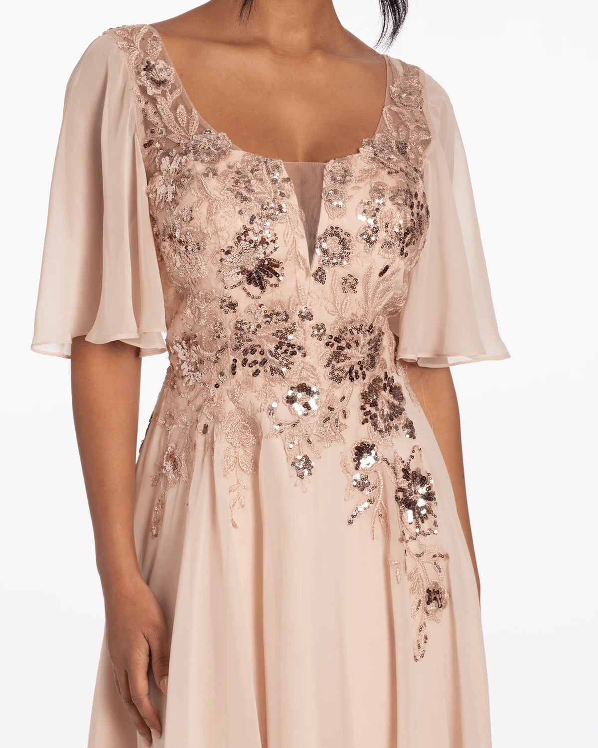 Close-up of blush sequin-embroidered bodice with scoop neck and sheer flutter sleeves