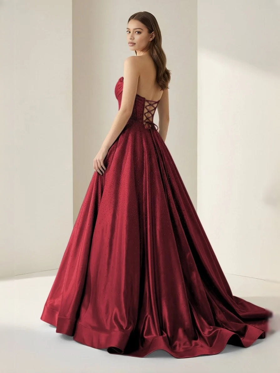 Burgundy strapless corset ball gown with crisscross lace-up back and full skirt