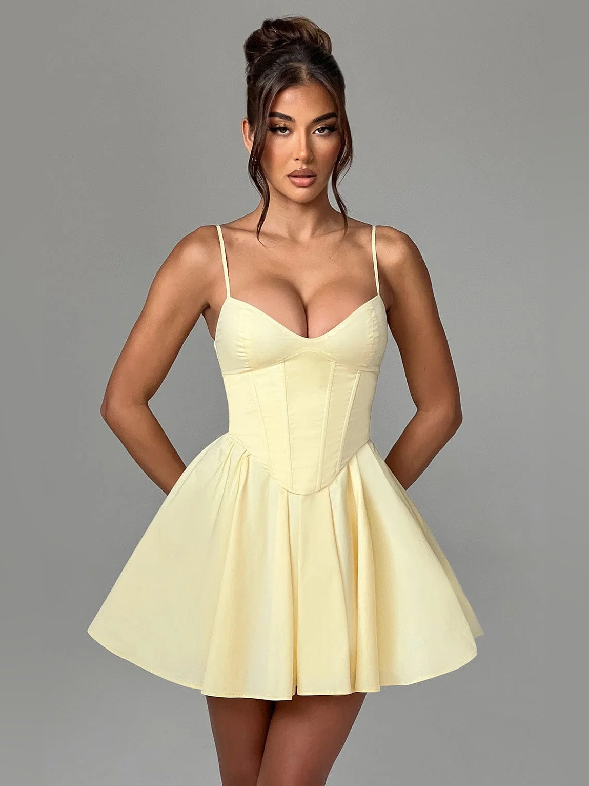 Lemon mini dress with spaghetti straps, corset bodice, and flared pleated skirt