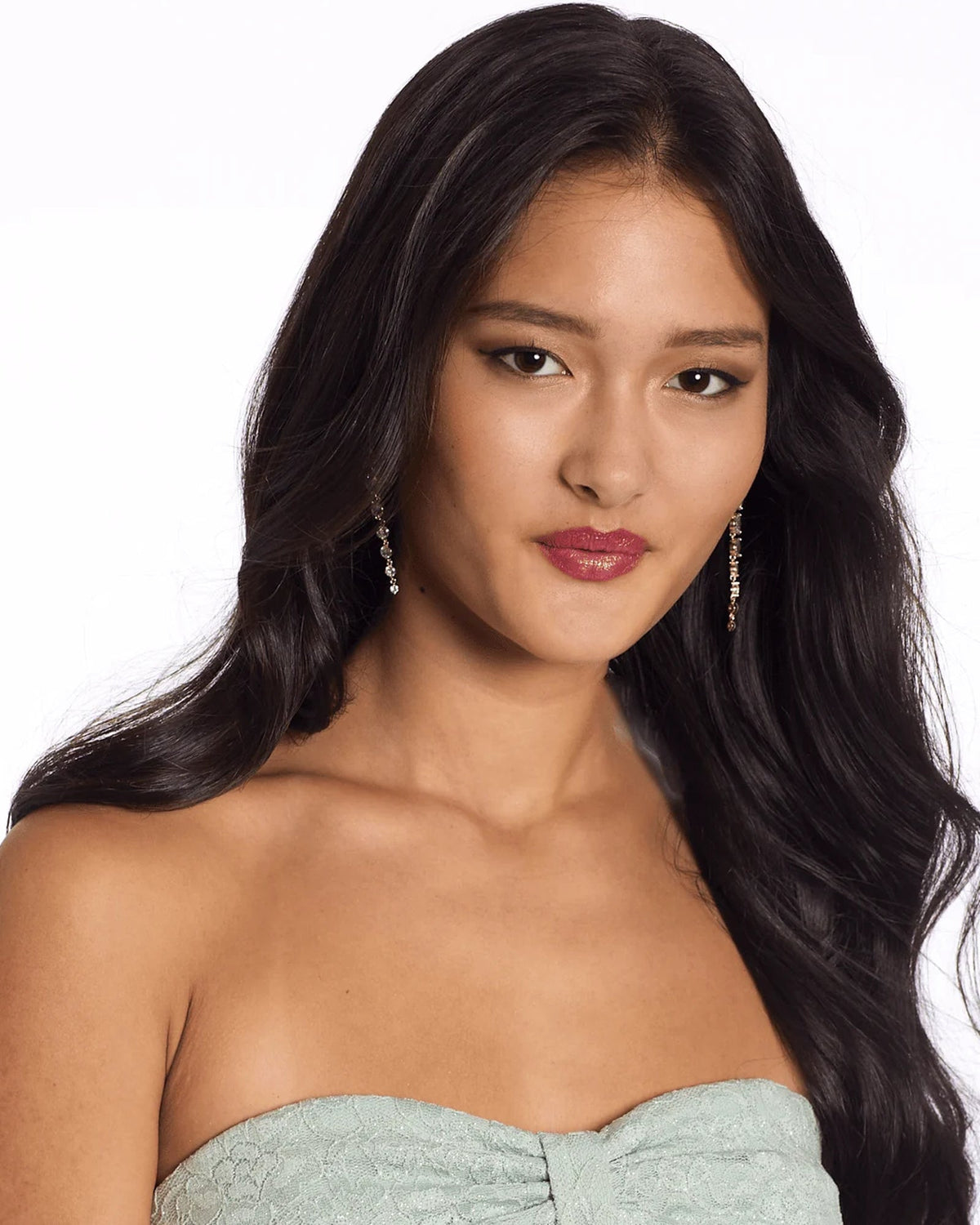 Close-up of sage strapless lace bodice and bow detail on fit-and-flare dress