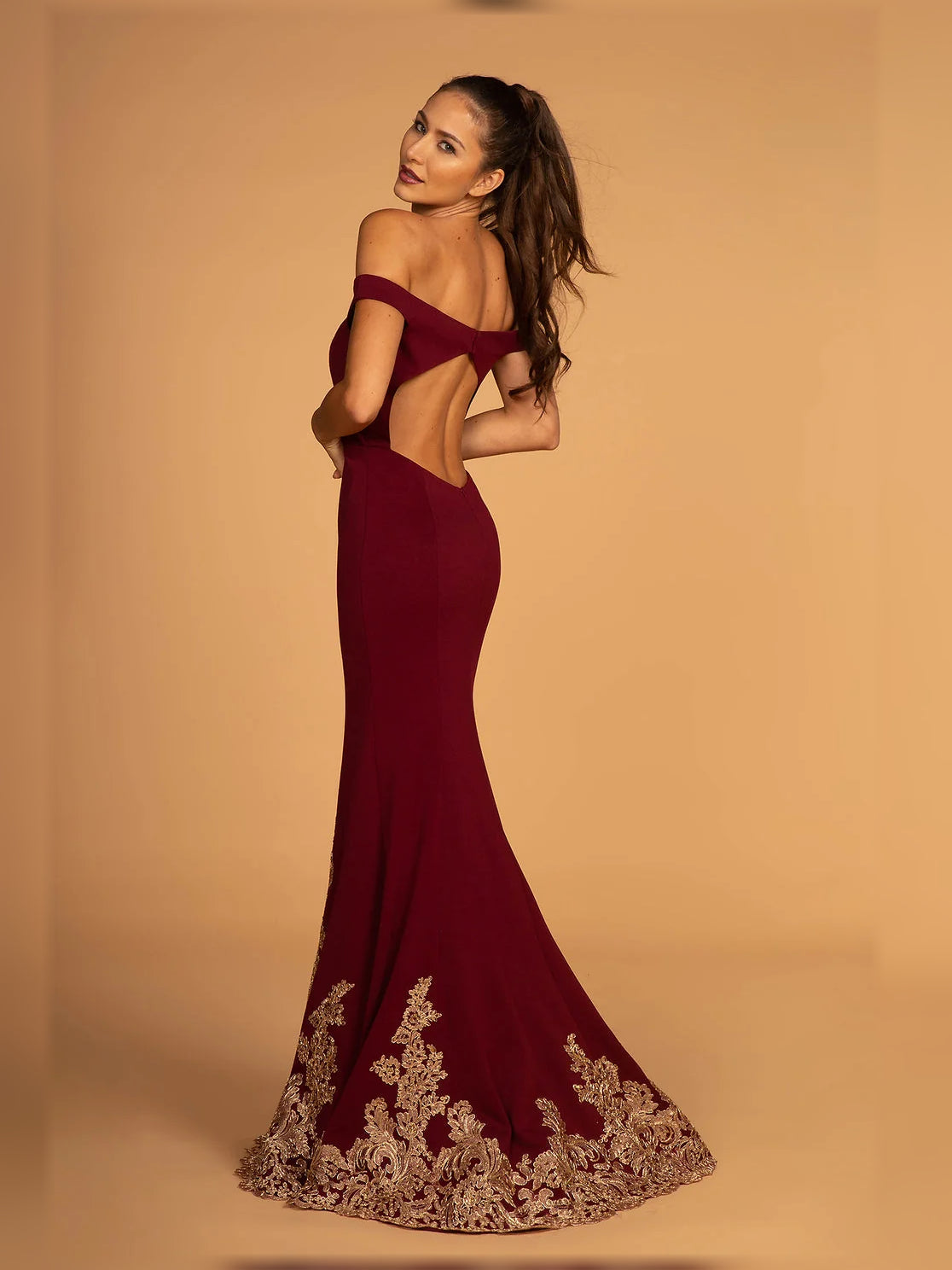 Burgundy off-shoulder maxi dress with gold floral embroidered hem.