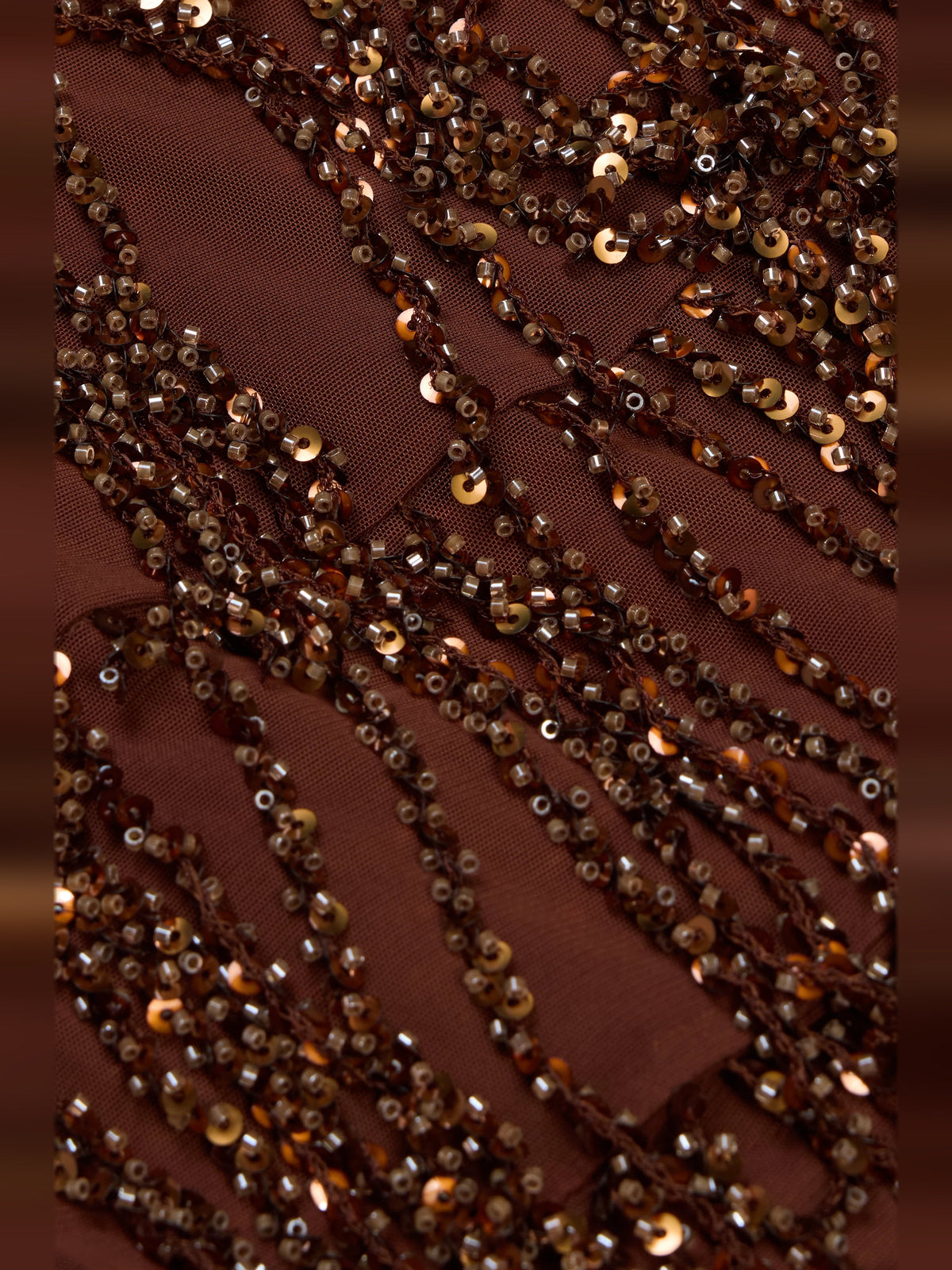 Close-up of brown sequin and bead fringe detailing on the mini dress