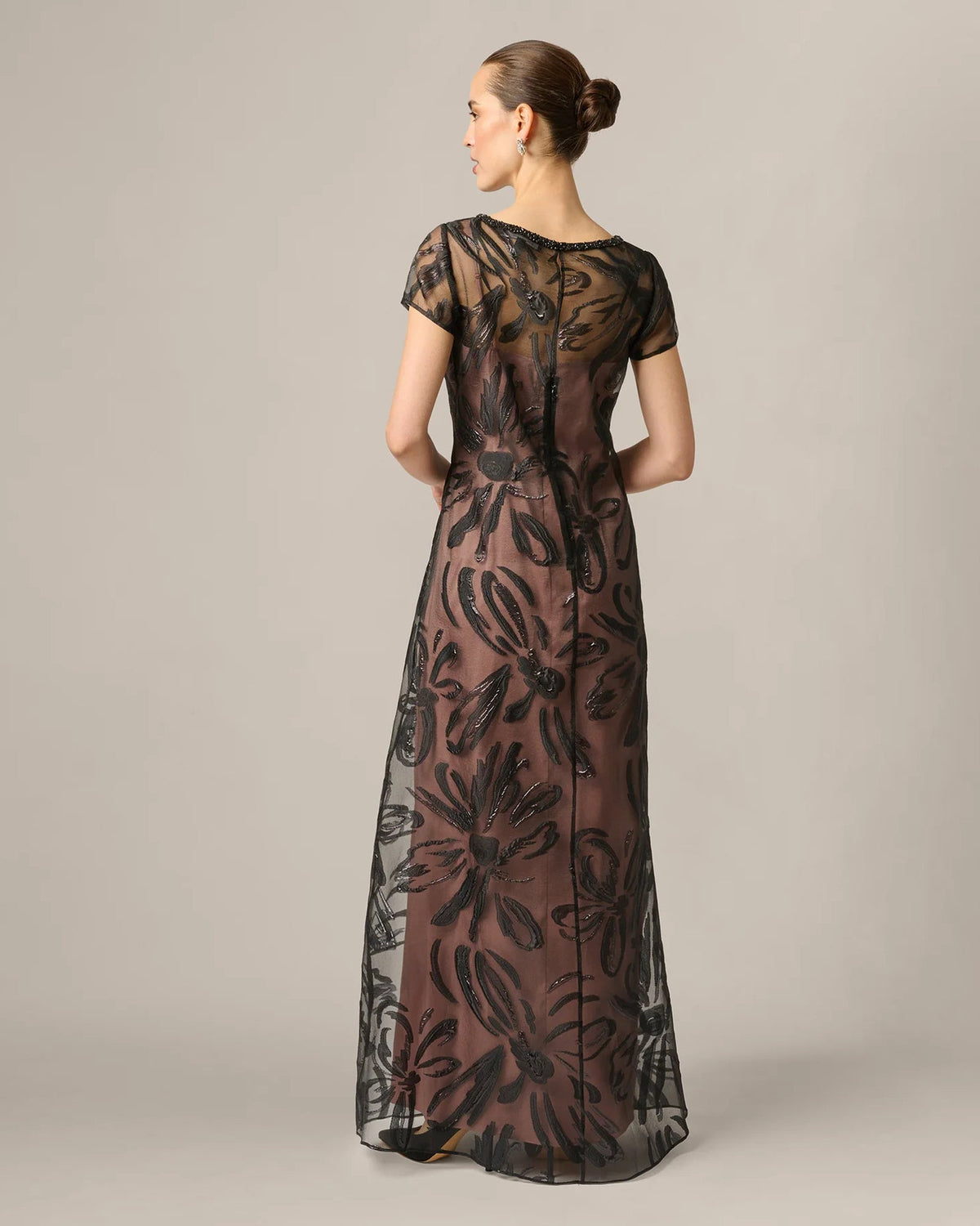 Black A-line maxi dress, short sleeves, back view with center seam and floral embroidery