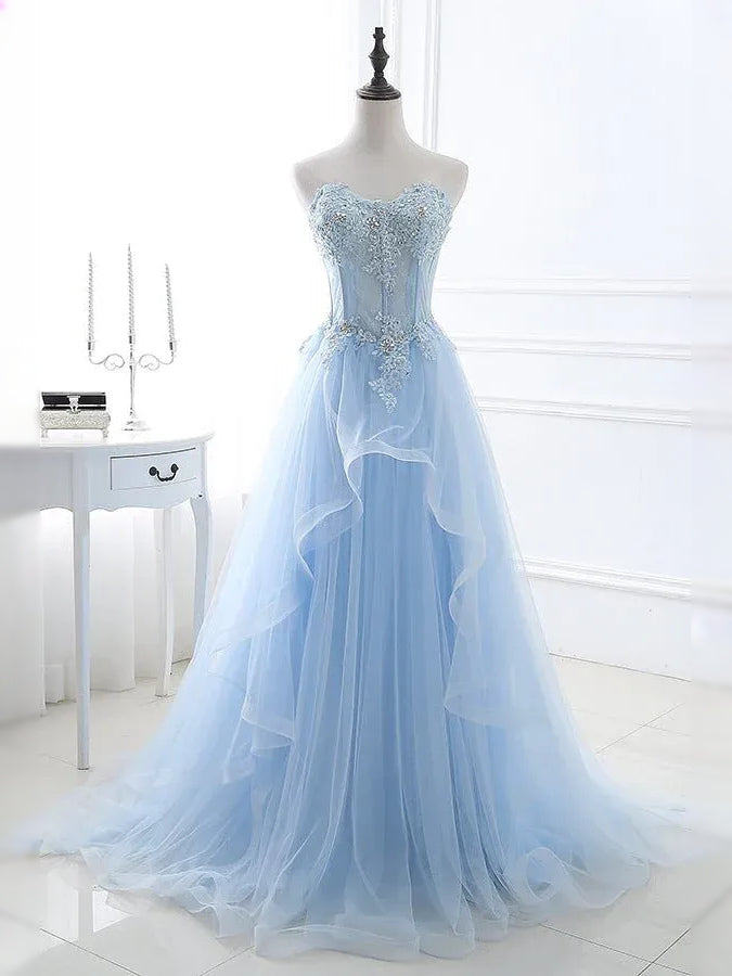 Light blue tulle ball gown on mannequin, embroidered corset bodice and full layered skirt