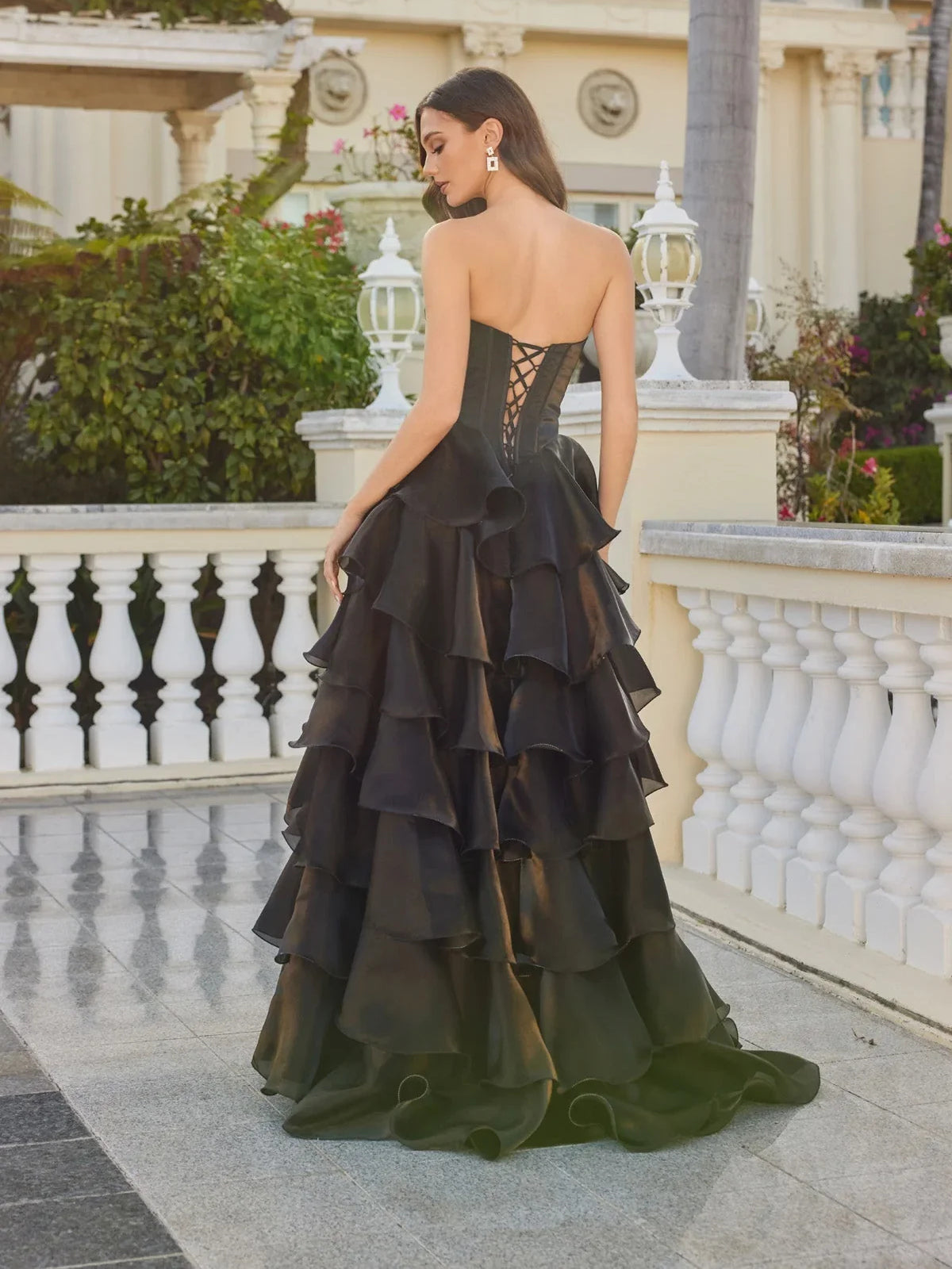 Black tiered corset ball gown prom dress with open back and layered ruffle skirt