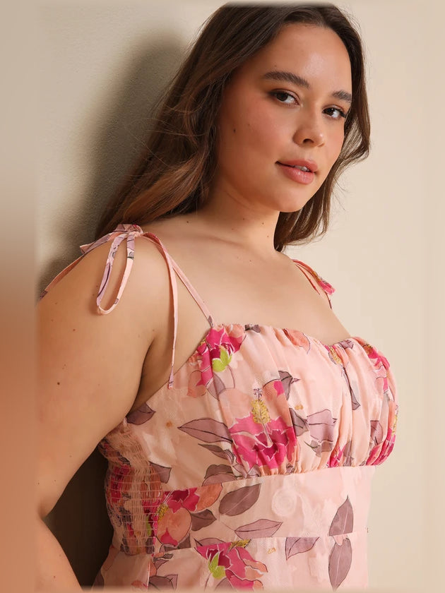 Pink floral tiered midi dress with adjustable tie shoulder straps, bust gathered