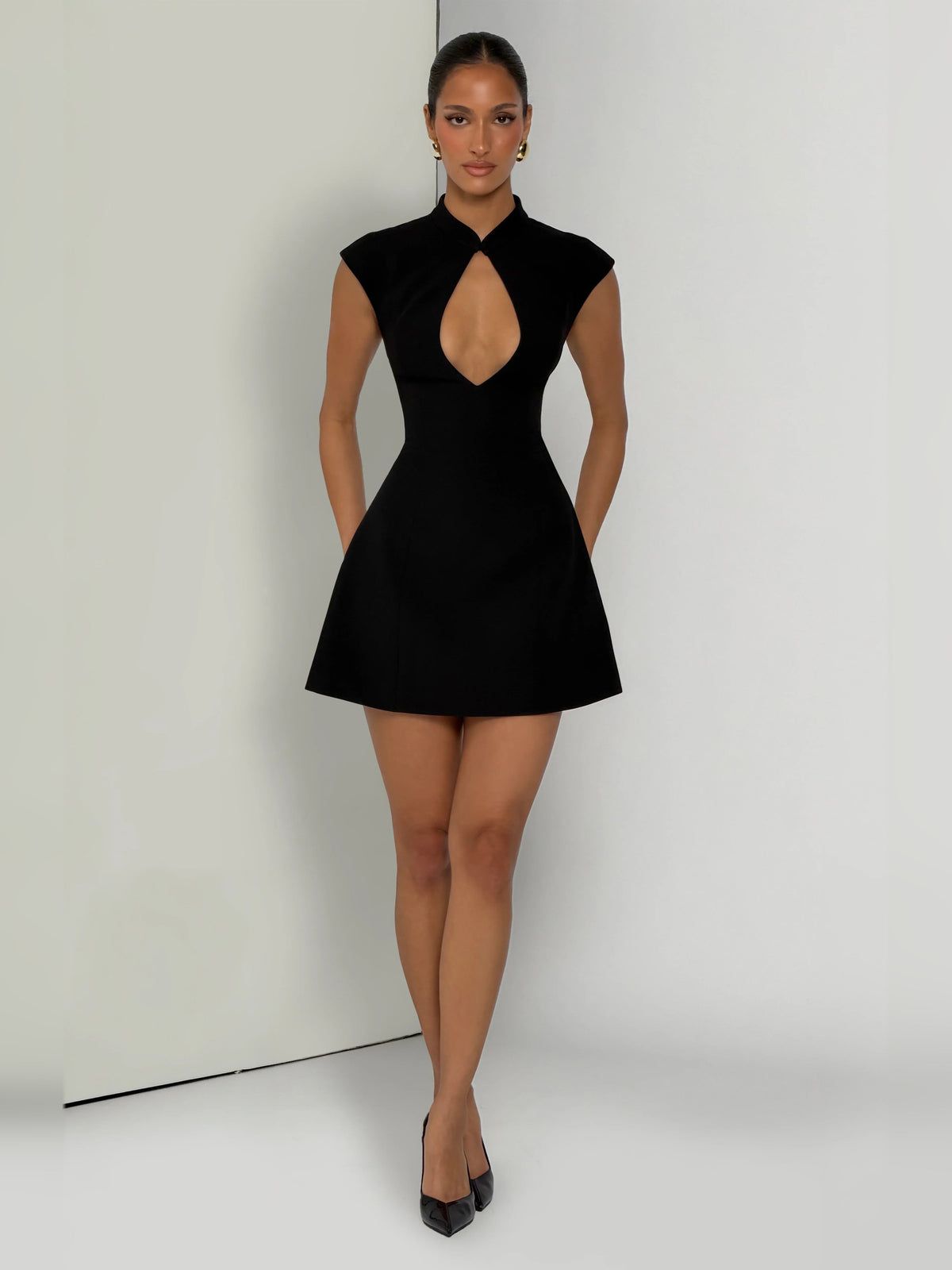 Black sleeveless A-line mini dress with keyhole neckline and layered flare skirt