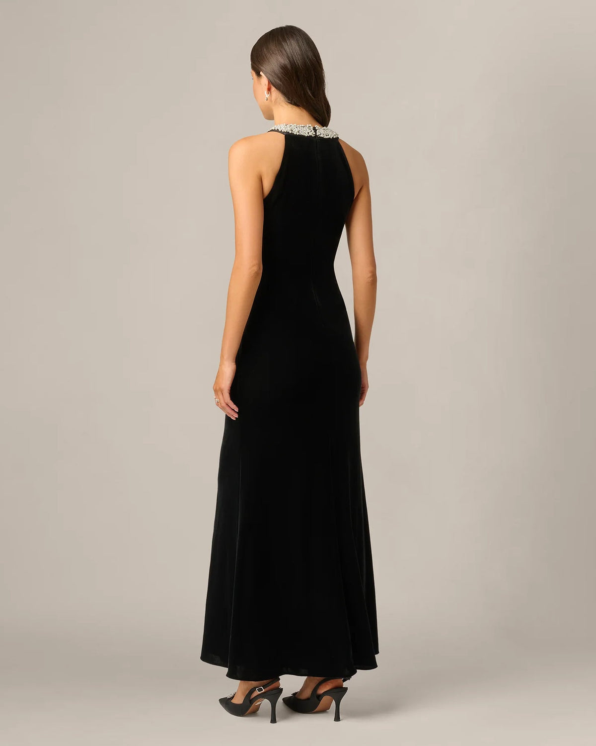 Black halter maxi dress from back view with sleek fitted bodice and flowing skirt
