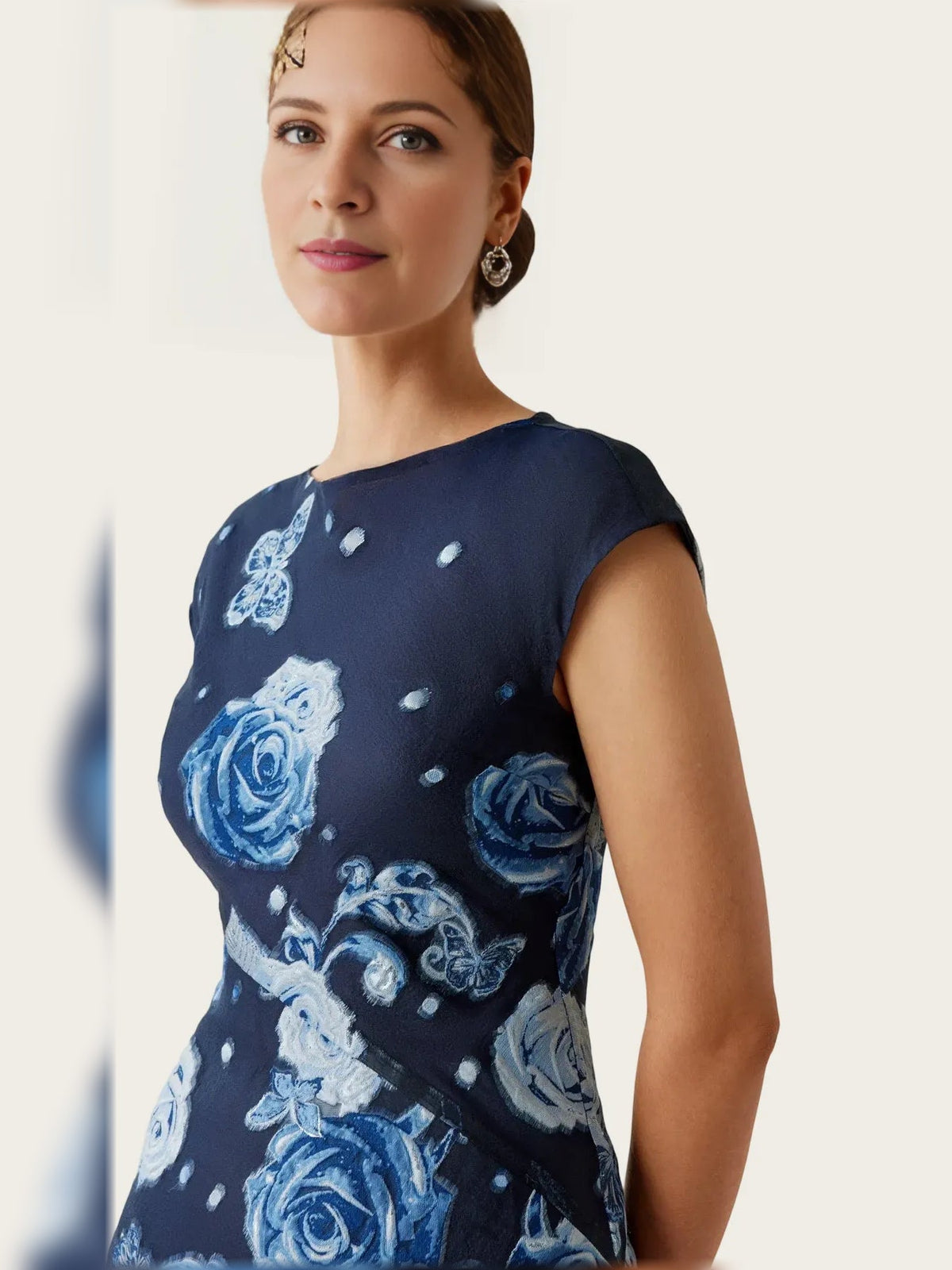 Close-up of navy cap-sleeve maxi dress with blue rose floral pattern and round neckline