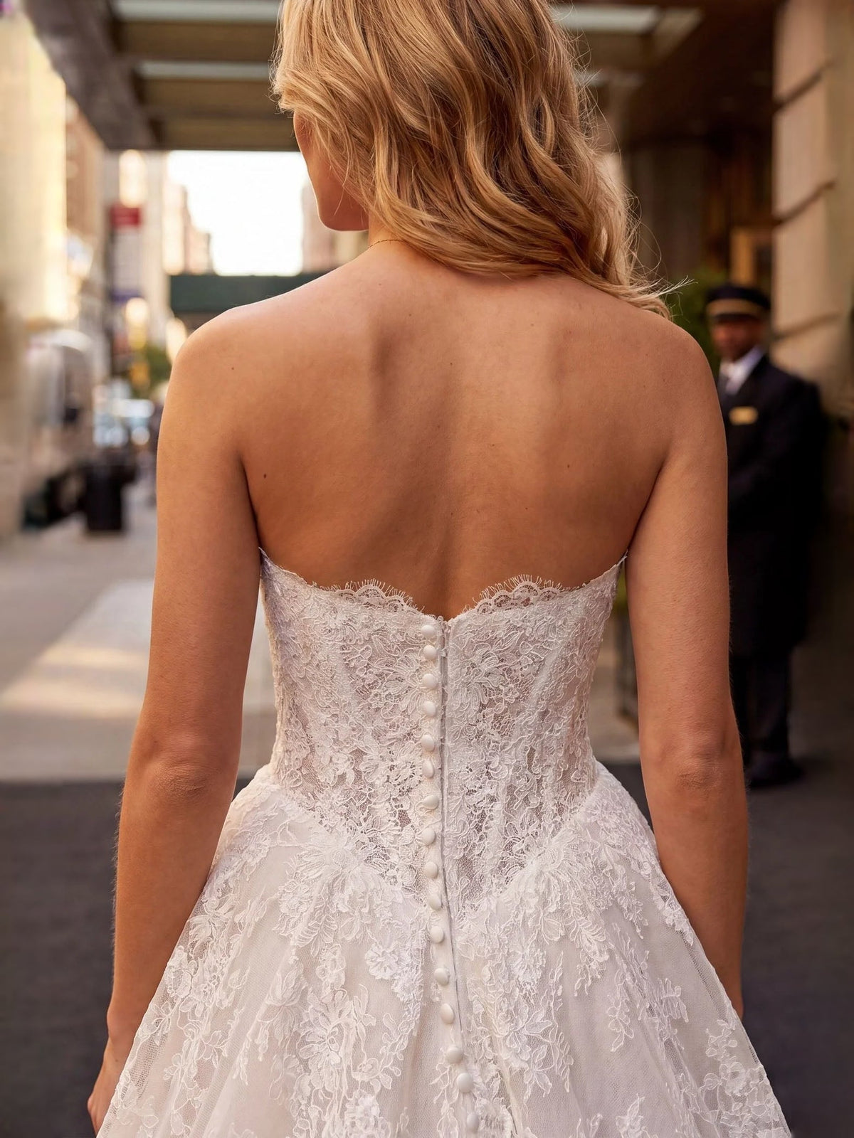 Ivory tulle A-line wedding dress back view with lace panel and vertical button closure