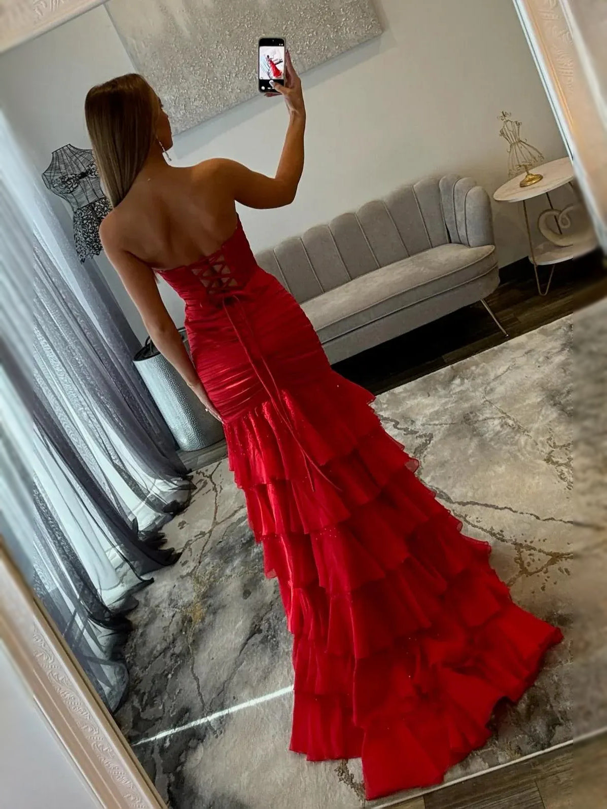 Red ruched corset prom dress with back lattice detail and tiered ruffles