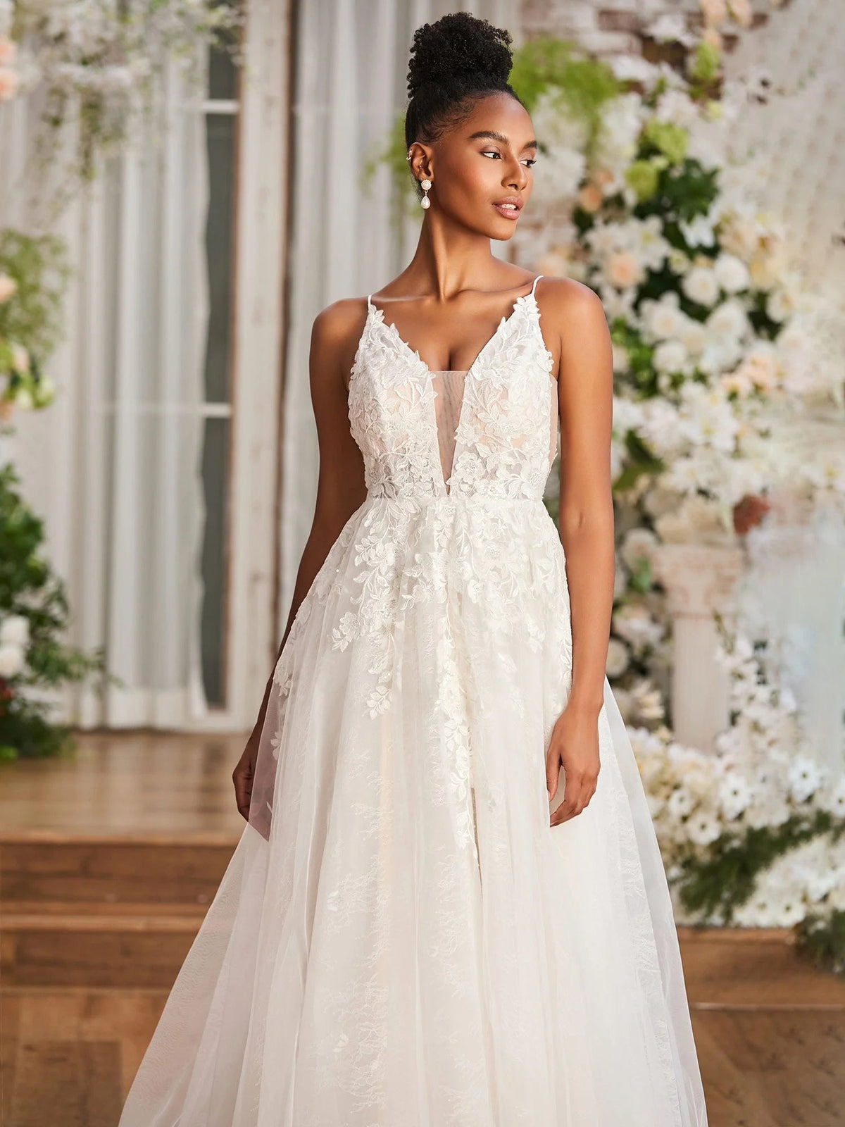 Ivory sleeveless V-neck wedding dress with lace bodice, layered tulle A-line skirt