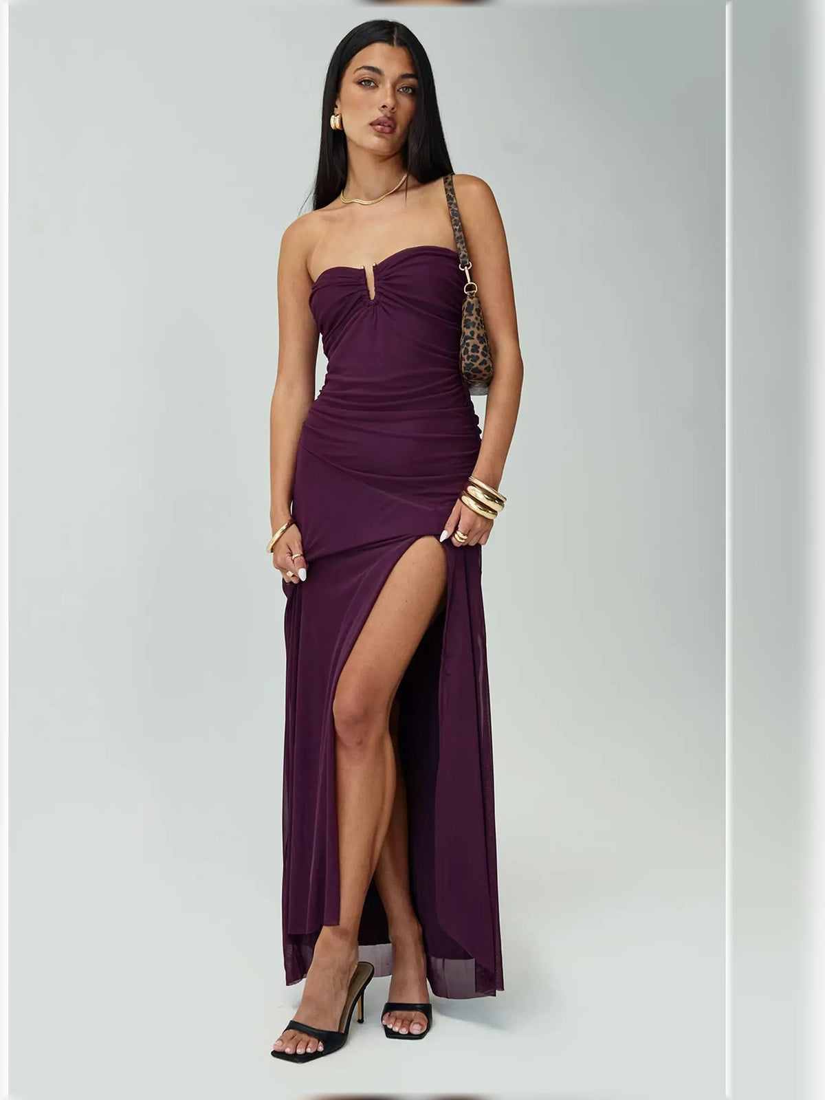 Purple strapless ruched formal maxi dress with thigh slit and flowing draped bodice
