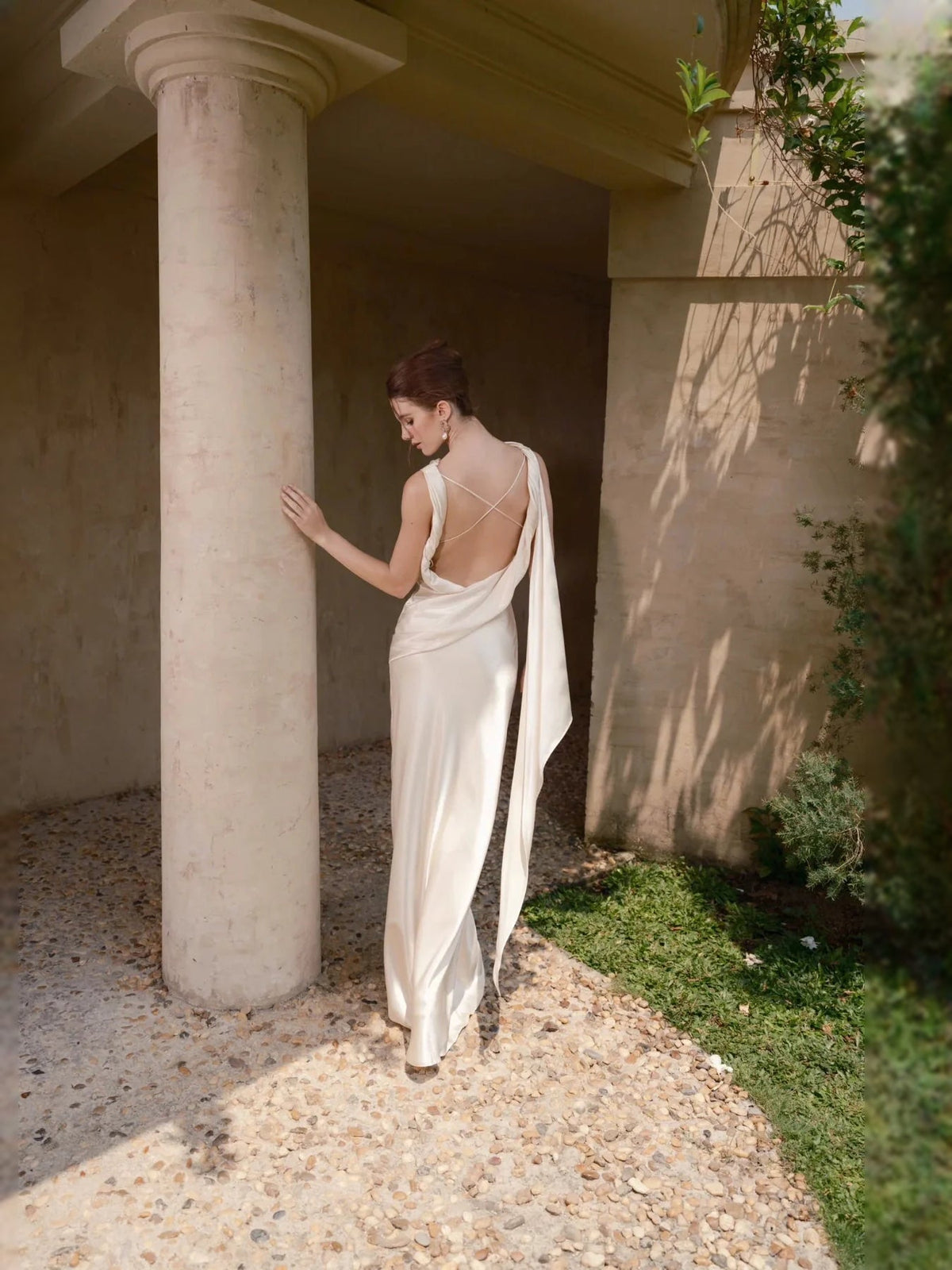 Ivory satin sheath wedding dress with cowl neckline, draped back, and high side slit