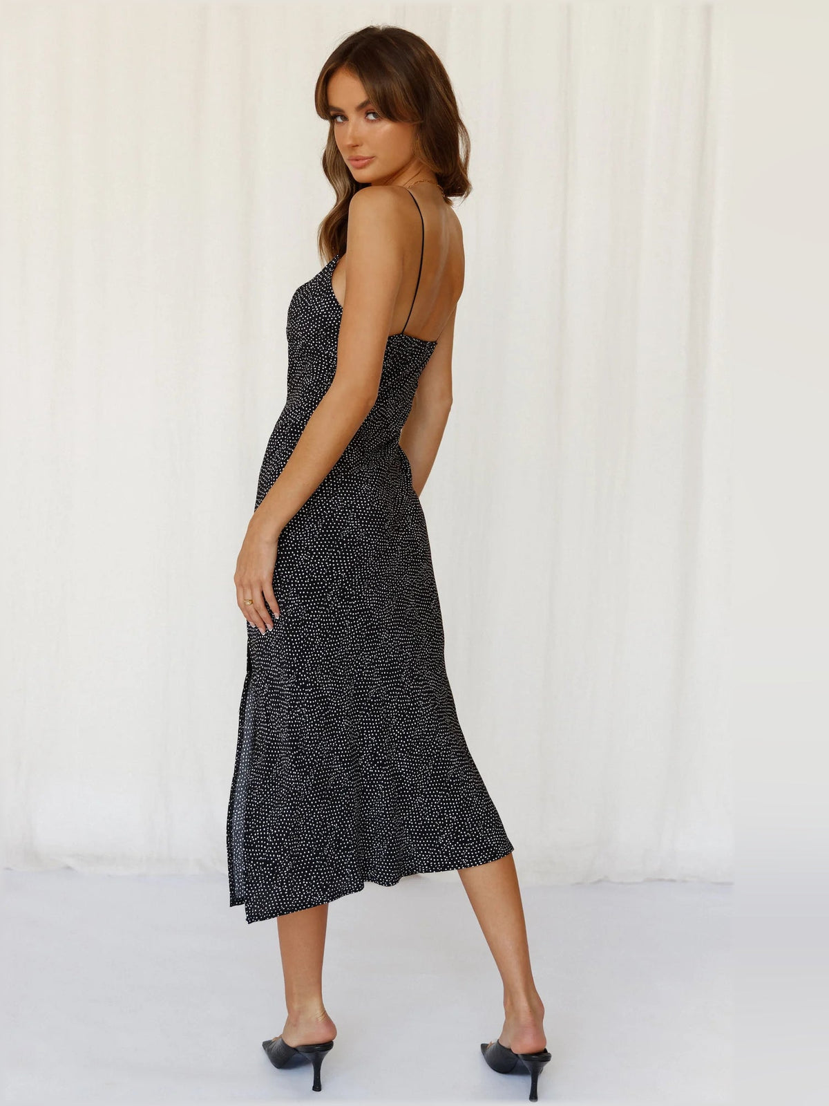 Black midi formal dress in side profile with V-neck and long side slit