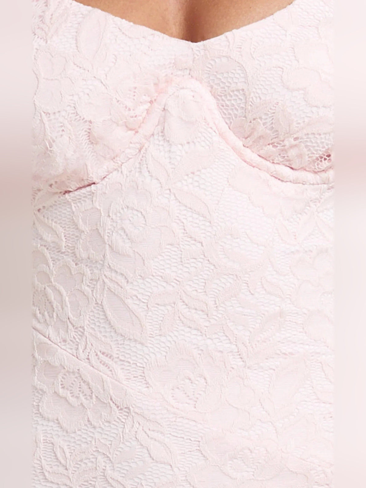 Pink textured lace fabric close-up with off-shoulder neckline edge detail