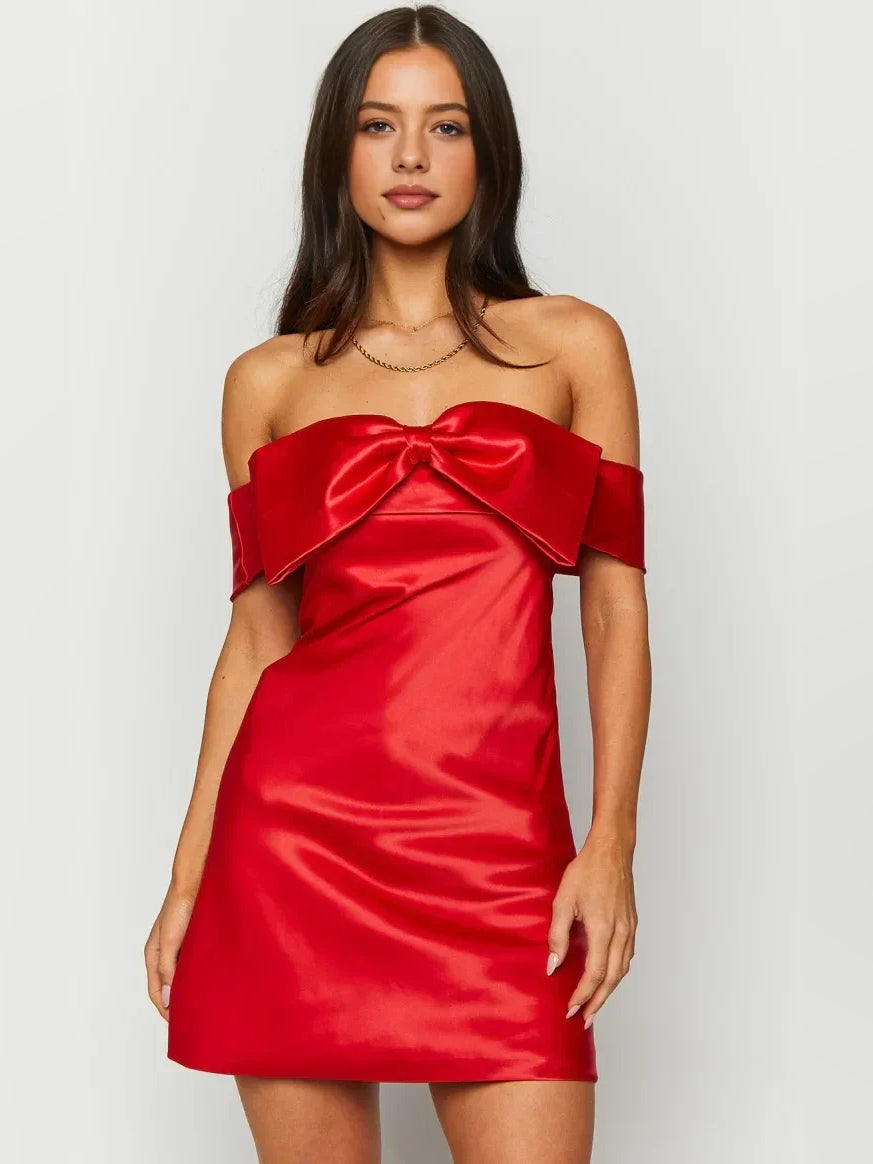 Red satin off-shoulder mini dress with oversized bow at neckline, fitted A-line shape