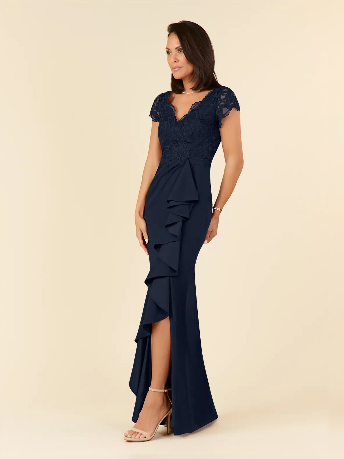 Dark navy mermaid gown with V-neck lace bodice, layered ruffle accents, and side slit.