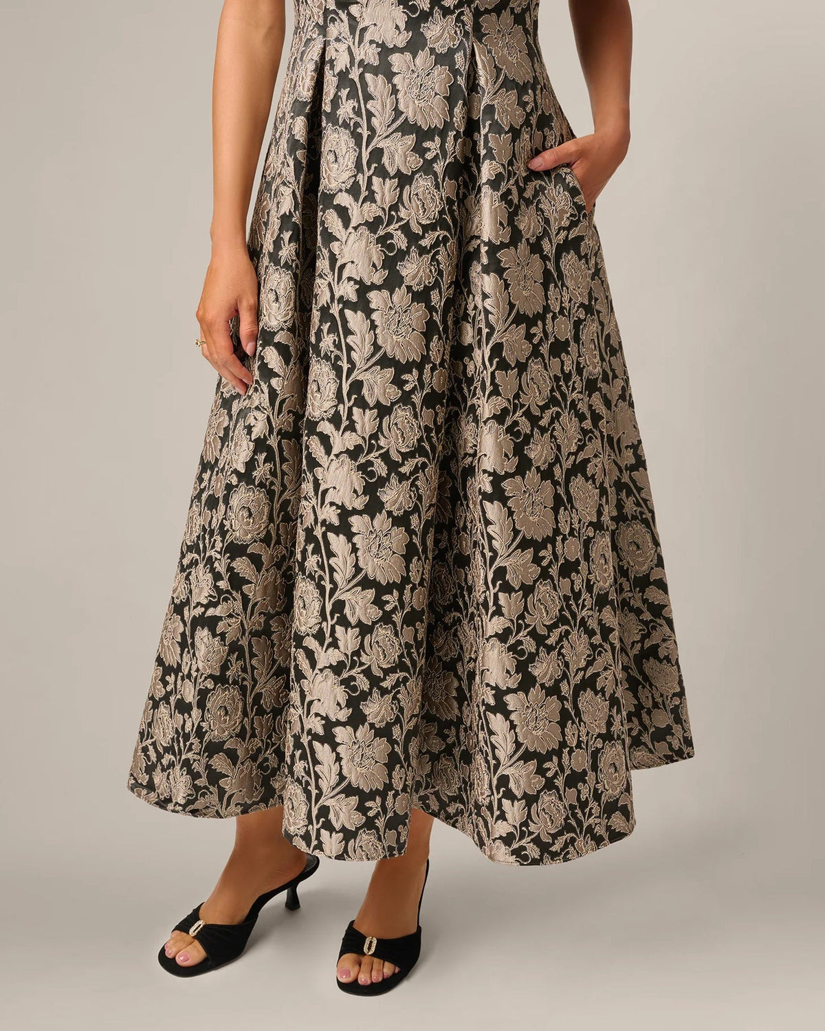 Black maxi skirt with taupe floral embroidery and gathered A-line silhouette