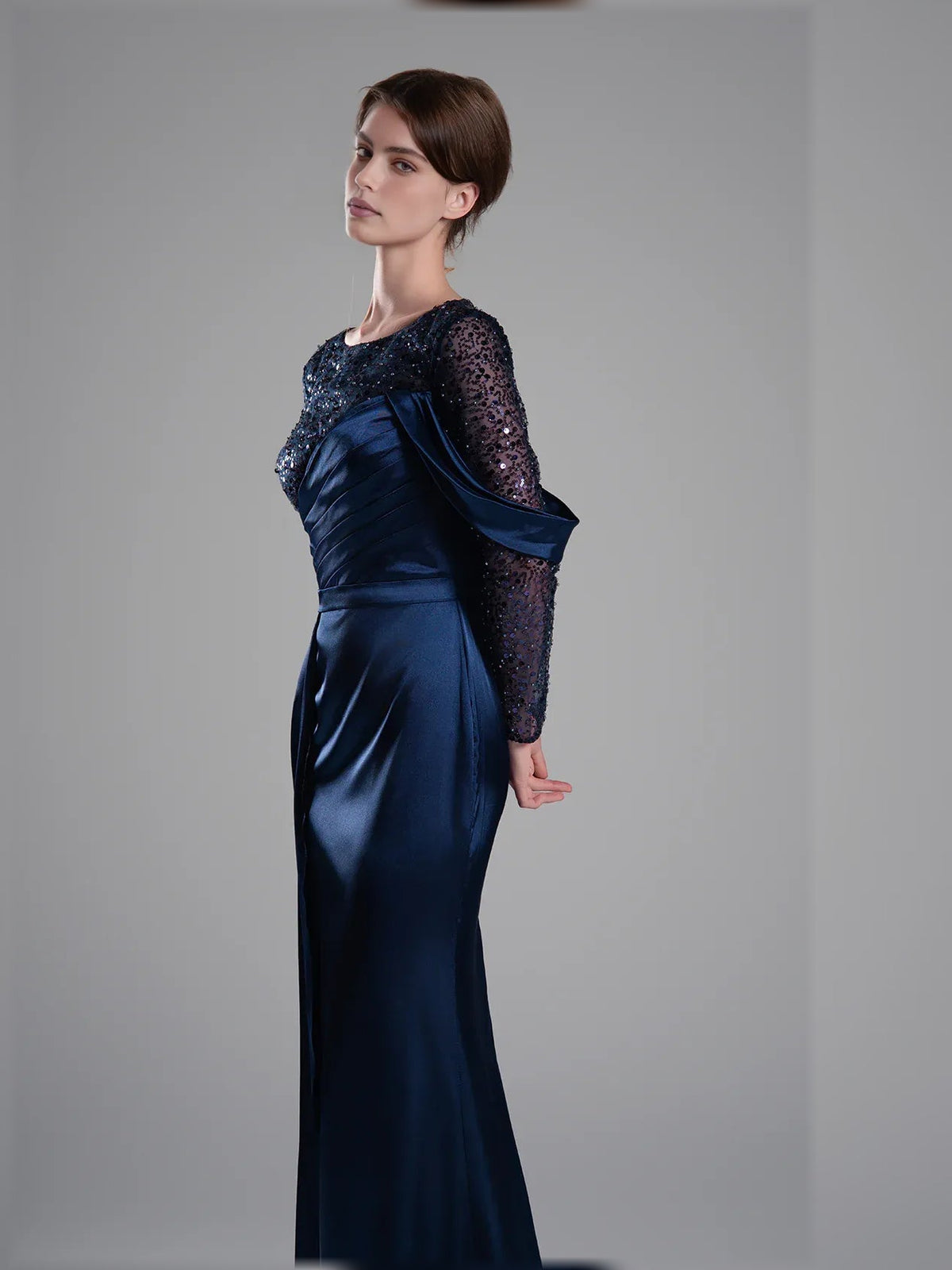Navy blue formal dress with beaded mesh long sleeves and ruched satin waist detail