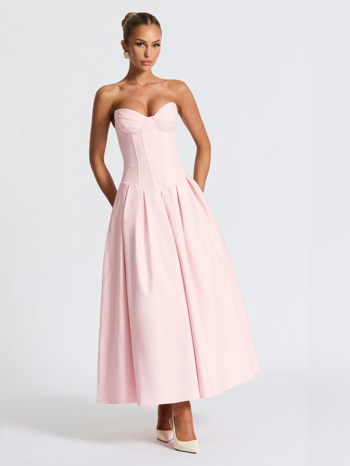 Blush pink strapless midi formal dress with sweetheart bodice and layered pleats