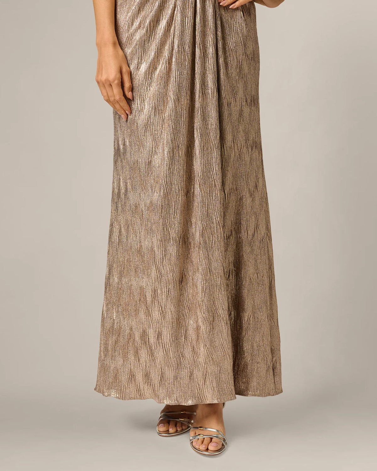 Rose-gold textured maxi skirt with front slit and draped waist detail