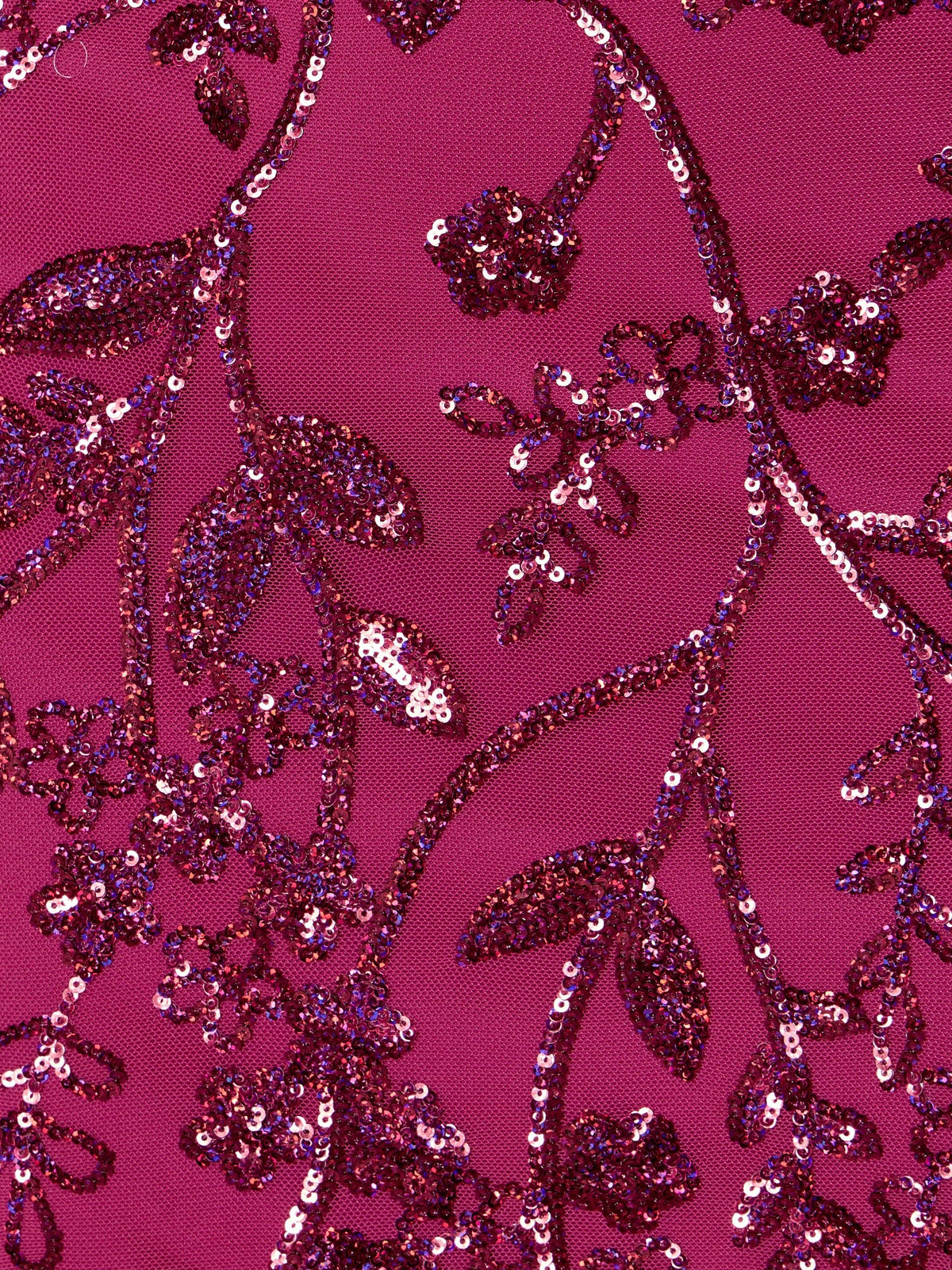Fuchsia sequin fabric close-up with dense shimmering sequin pattern