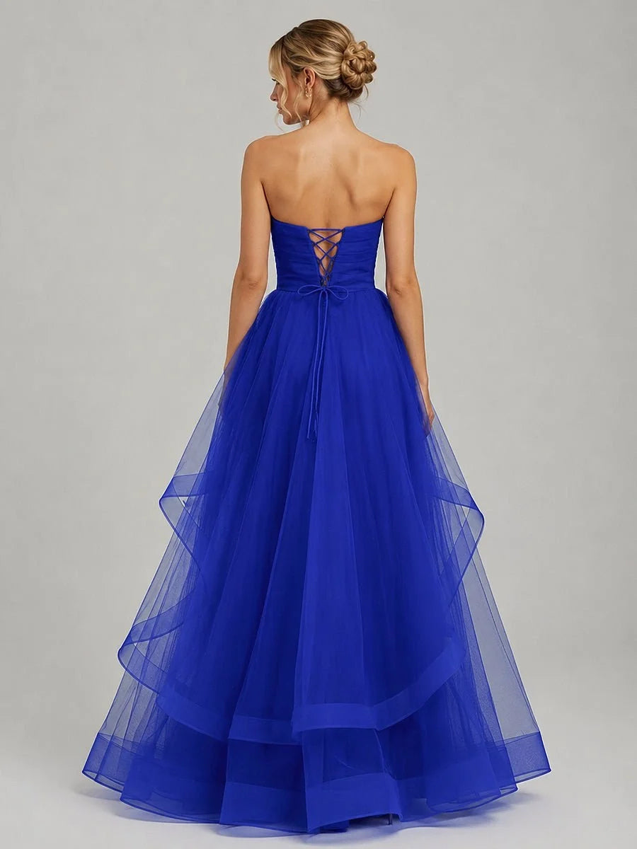 Royal blue strapless tulle prom dress with crisscross back detail and tiered ruffle skirt