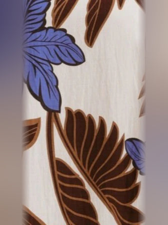 Close-up of chocolate and blue floral print fabric on a mini dress