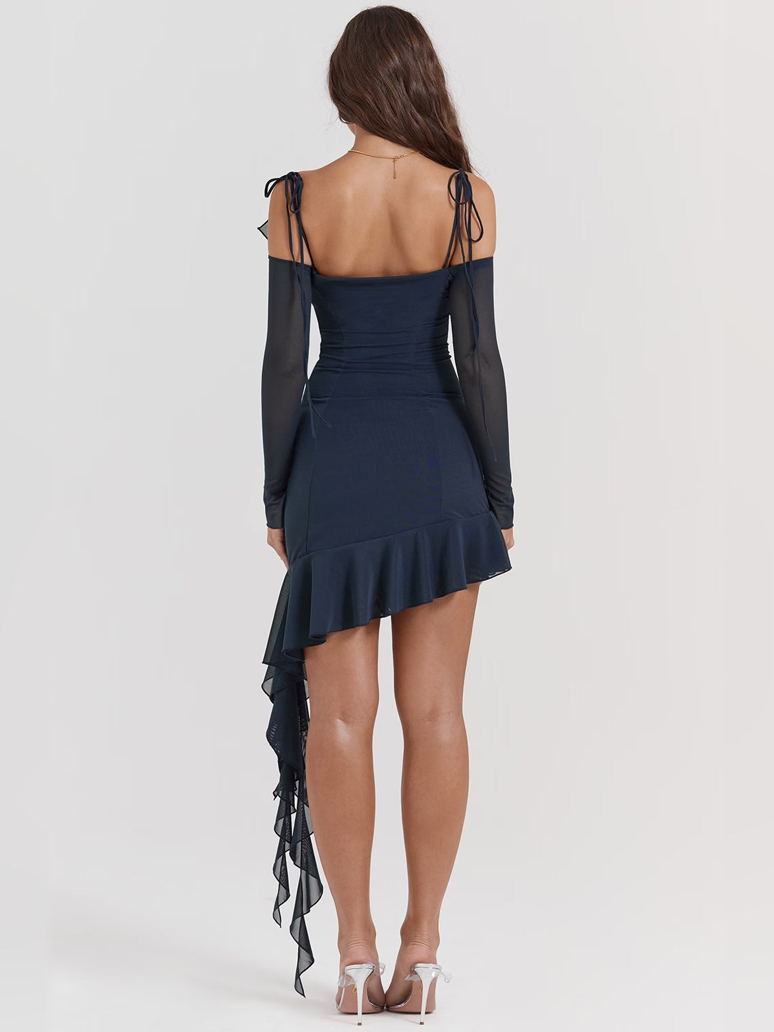 Navy backless mini dress with spaghetti straps, ruffled layered skirt, sheer long sleeves