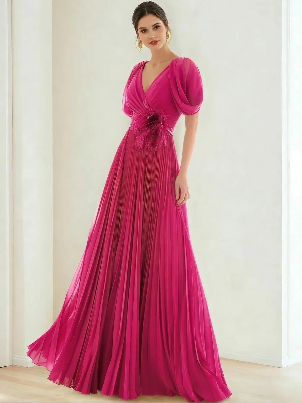 V-neck formal dress in fuchsia with puff sleeves, pleated skirt, and feathered waist detail