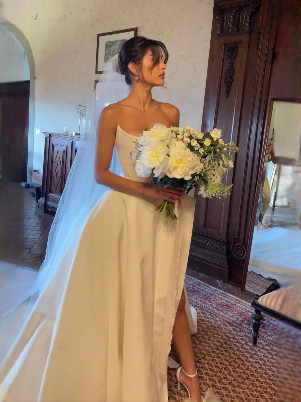 White satin sweetheart A-line wedding dress with draped waist and leg slit