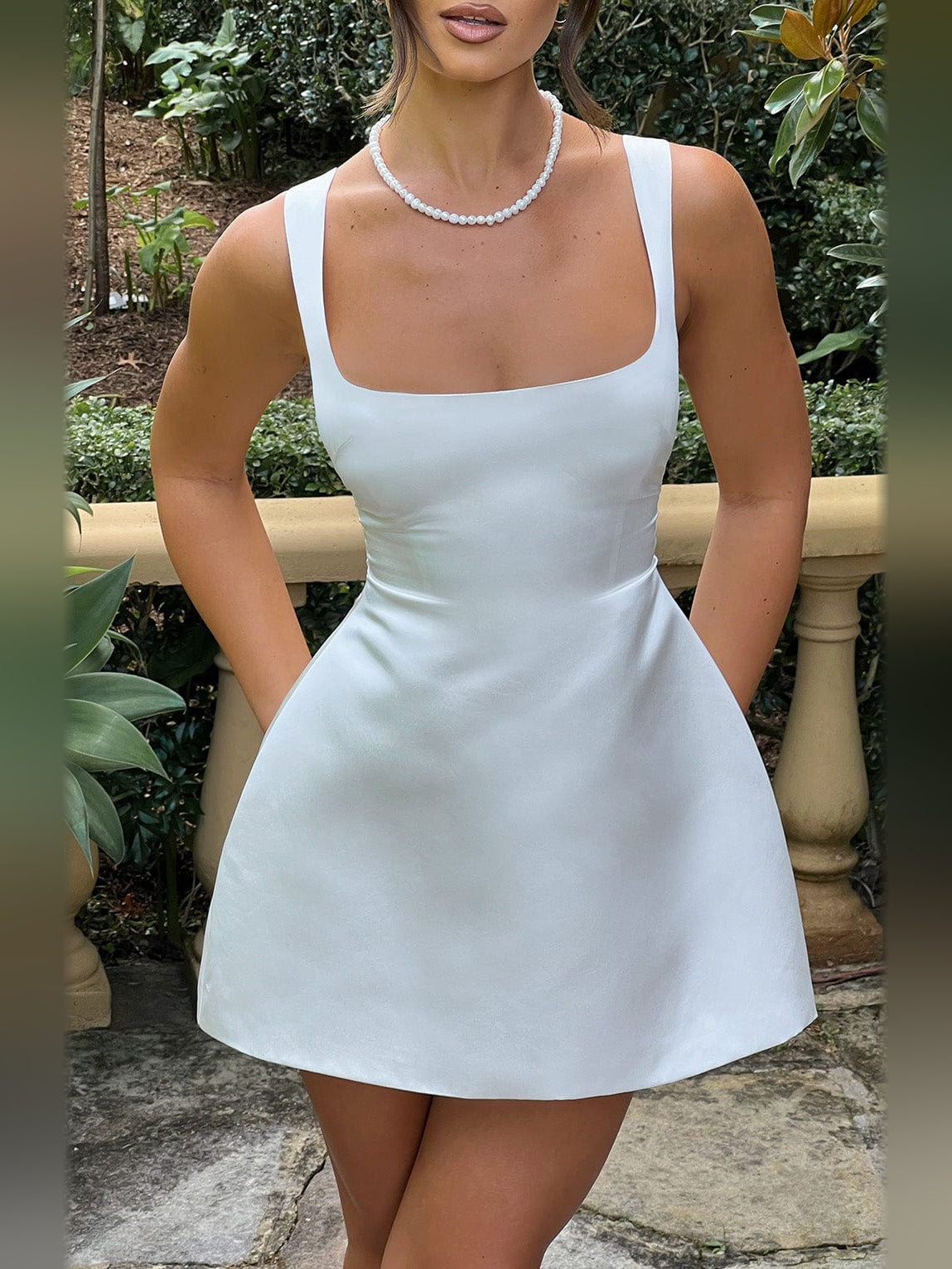 Ivory mini homecoming dress with pearl necklace; square neck and flared skirt