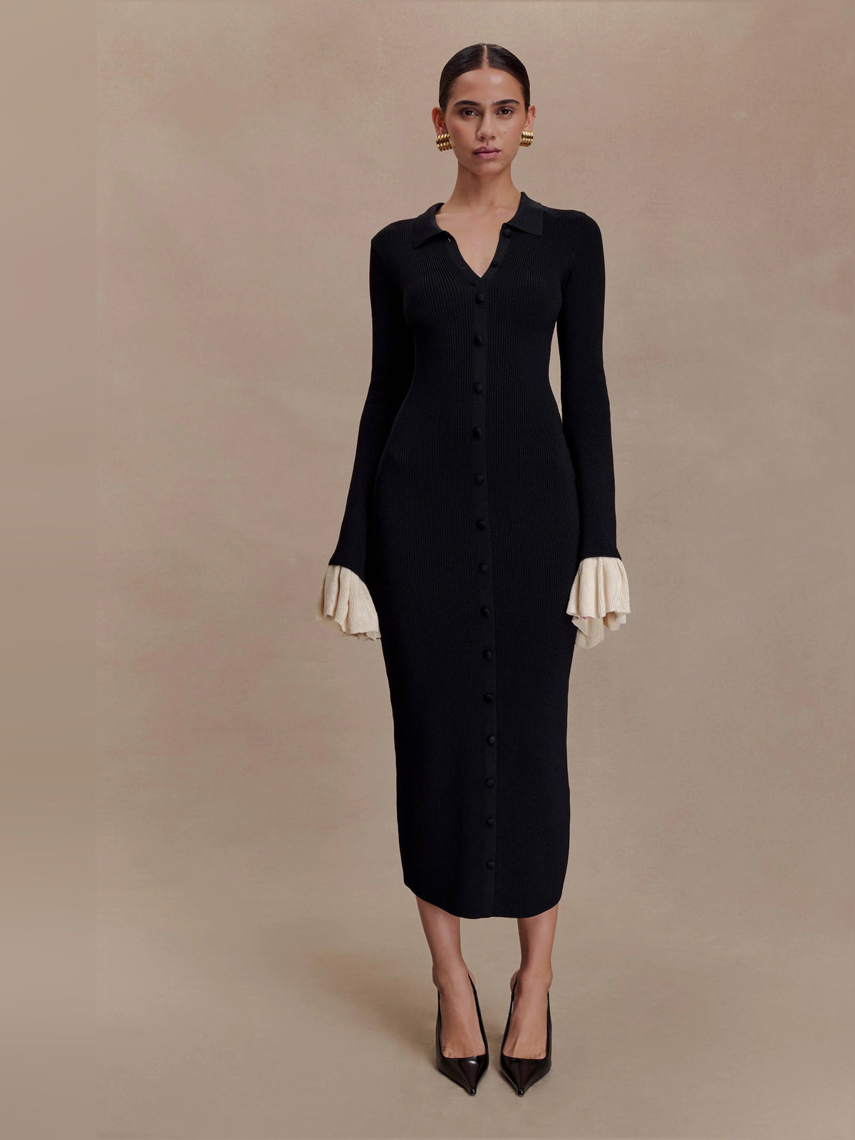 Amirose black knit midi dress with V-neck button front and long sleeves, cream ruffle cuffs