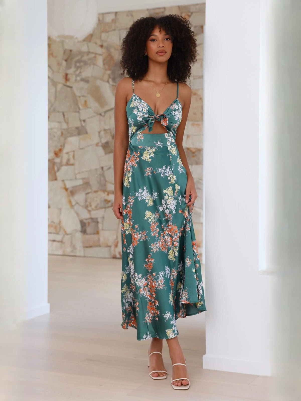 Green floral midi formal dress with bow-tie front, spaghetti straps, and flowing hem