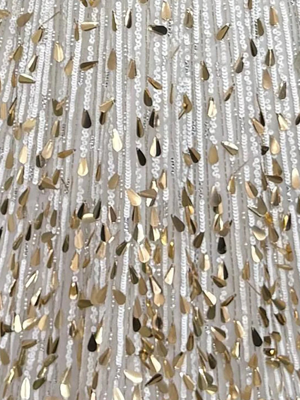 Close-up of gold and silver sequins on textured fabric