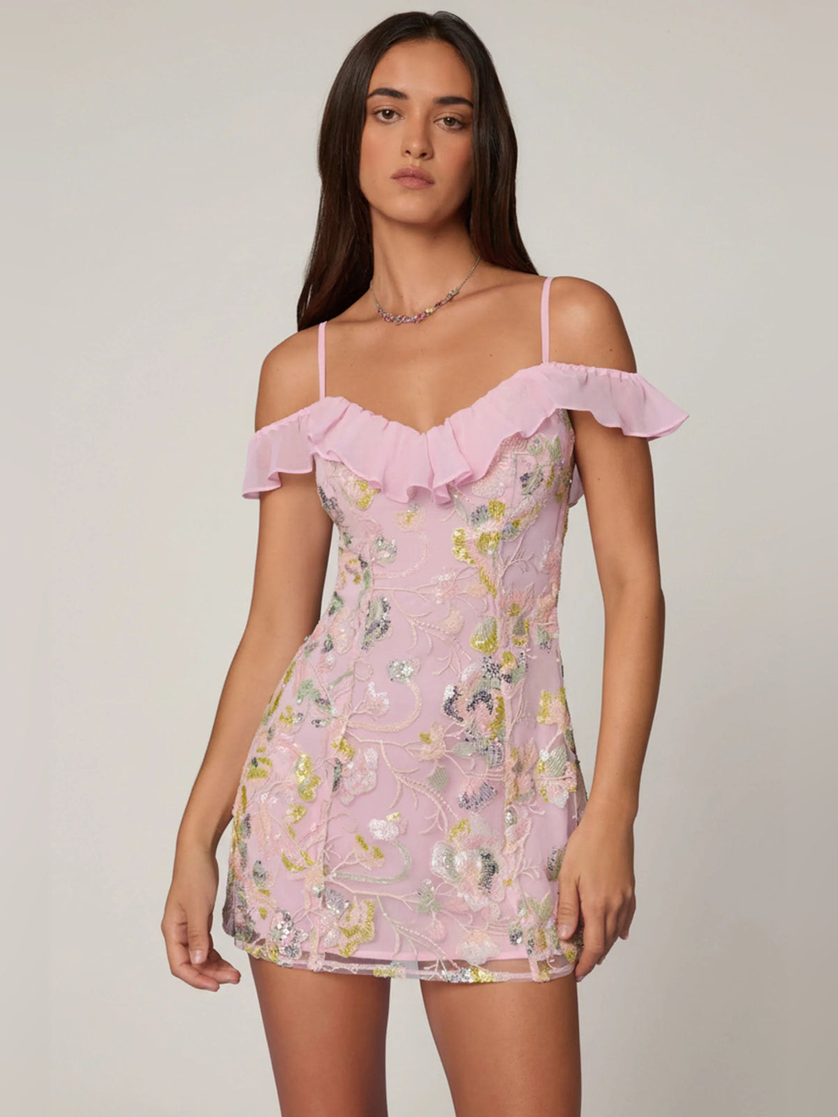 Pink A-line mini dress with ruffled off-shoulder neckline and sparkly floral embellishment