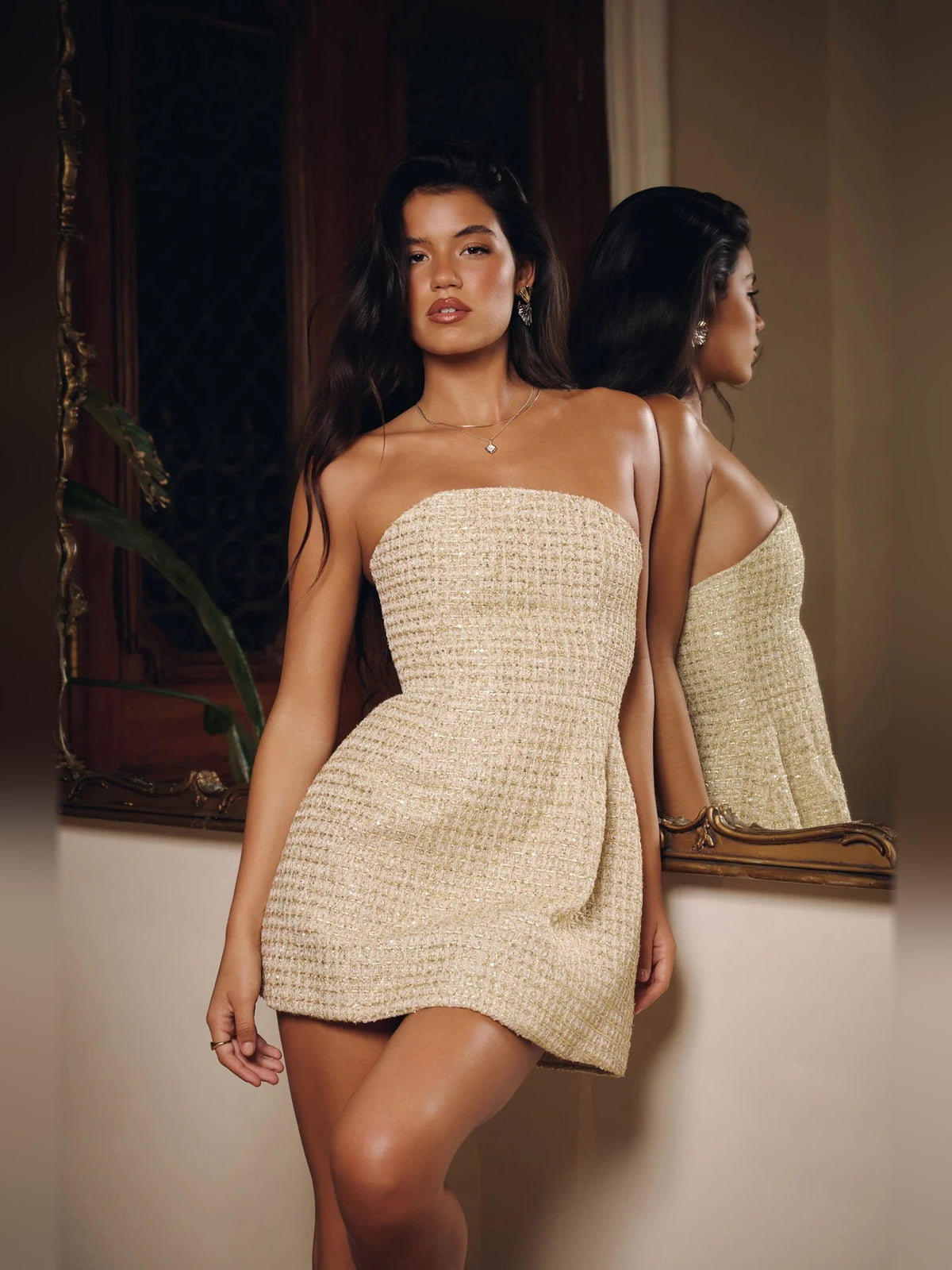 Gold strapless sequin mini dress, straight bandeau neckline and fitted skirt.