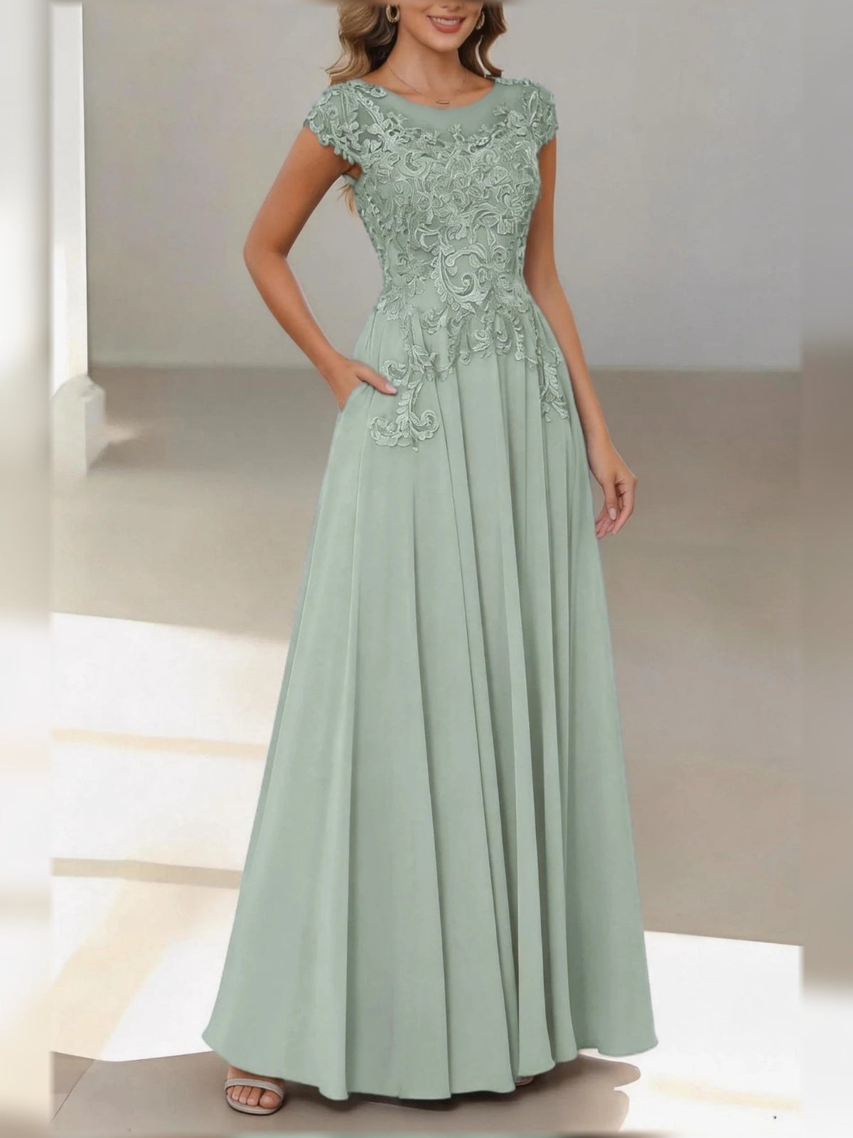Mint green satin A-line dress with lace cap sleeves and pleated floor-length skirt