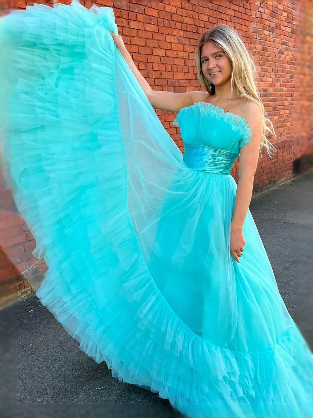 Ice blue strapless sweetheart maxi dress with ruched bodice and tiered ruffle tulle skirt.