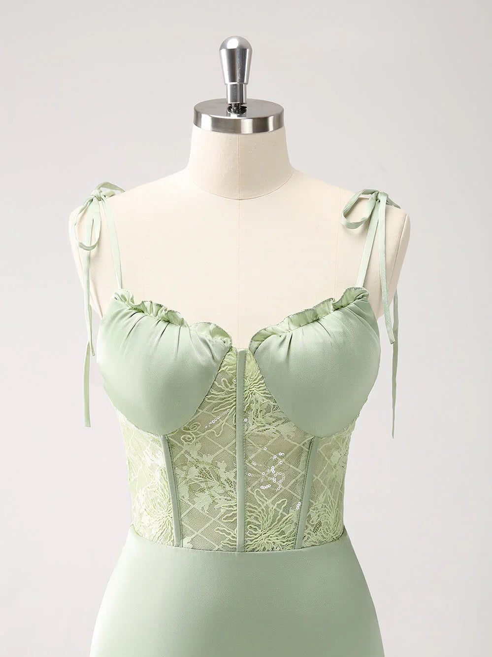 Celadon green corset-style formal dress on mannequin with gathered neckline detail