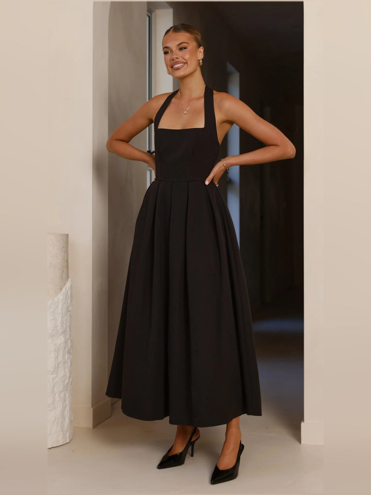 Black a-line maxi formal dress with halter neckline, alternate view showing the hem