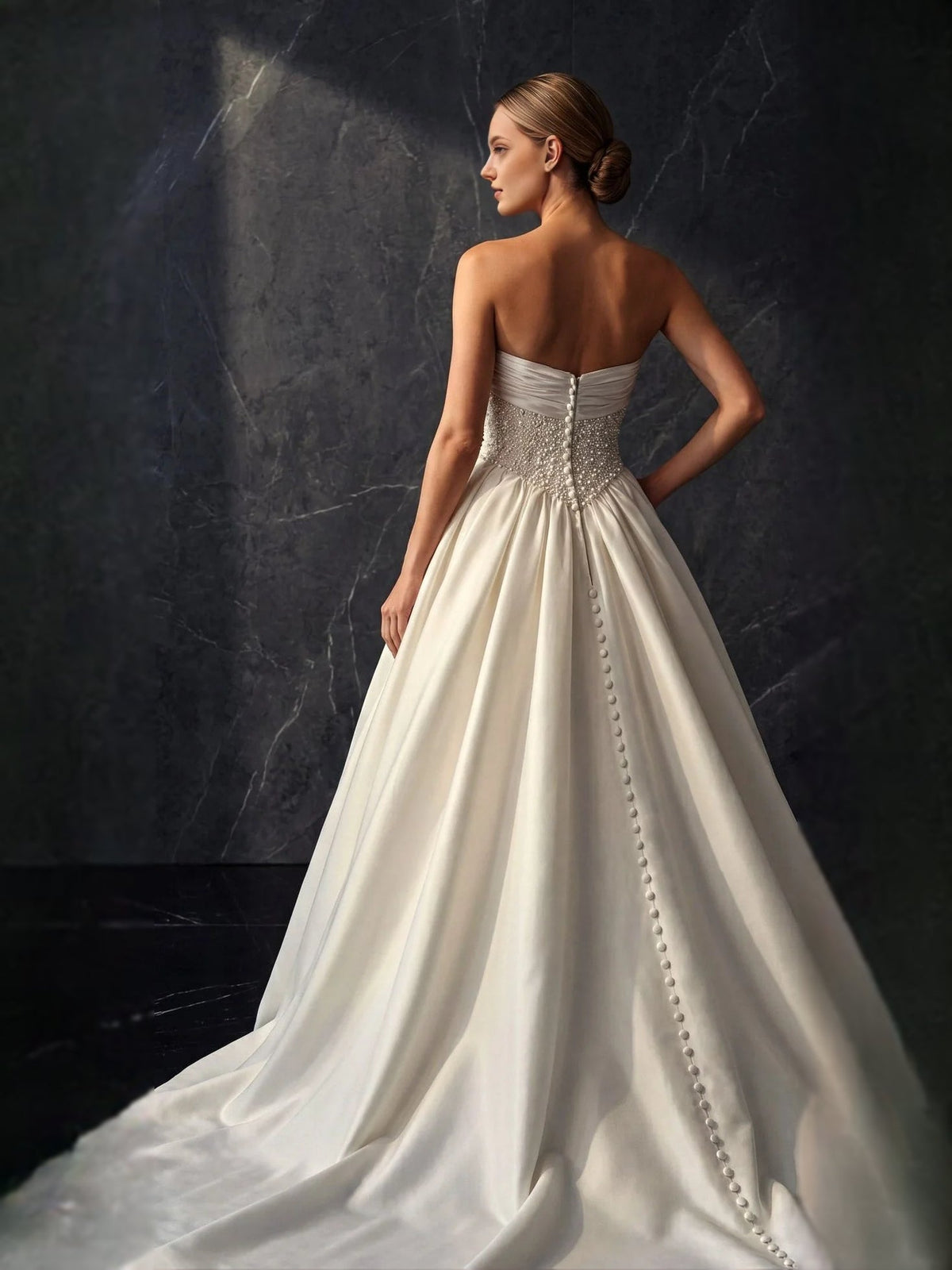 Ivory satin strapless A-line wedding dress with beaded center back and button trim